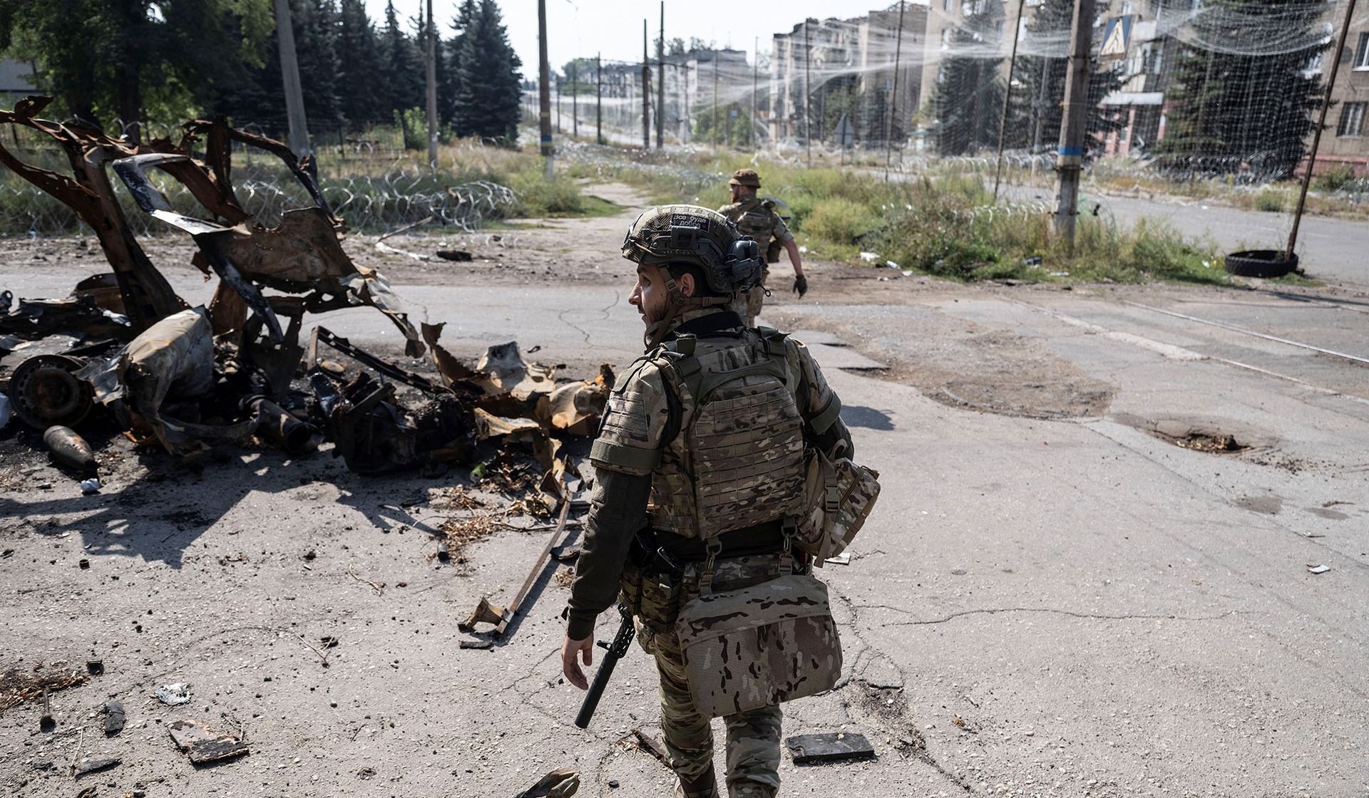 Servicemen of the 93rd Kholodnyi Yar Separate Mechanized Brigade of the Ukrainian Armed Forces walk on a street in the frontline town of Druzhkivka