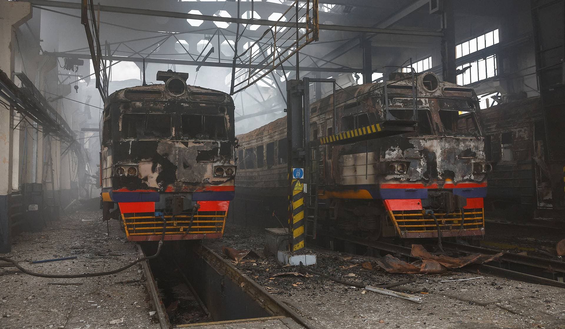 Burned electric trains stand inside a depot hit during an overnight Russian missile and drone strikes in the Kyiv Region
