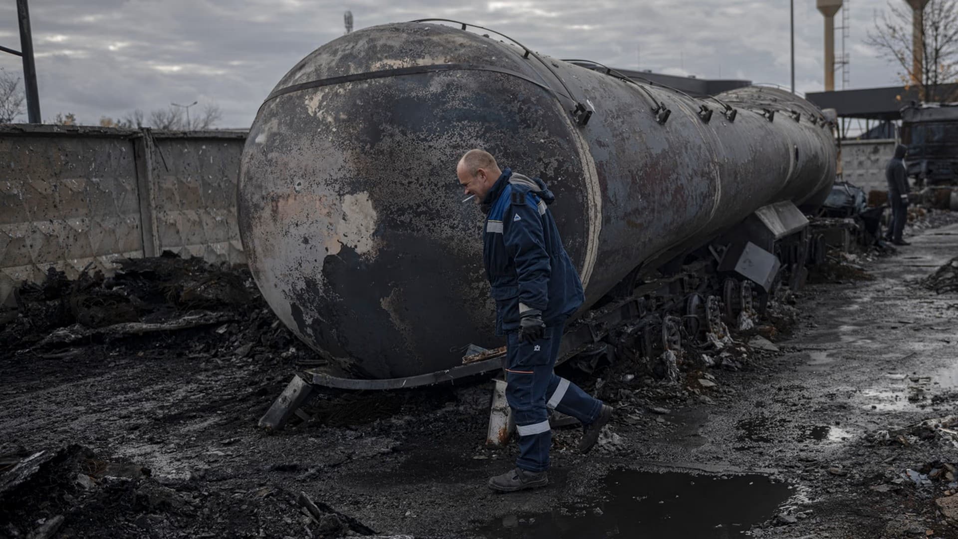 A worker walks at a fuel depot hit by Russian missile in the town of Kalynivka
