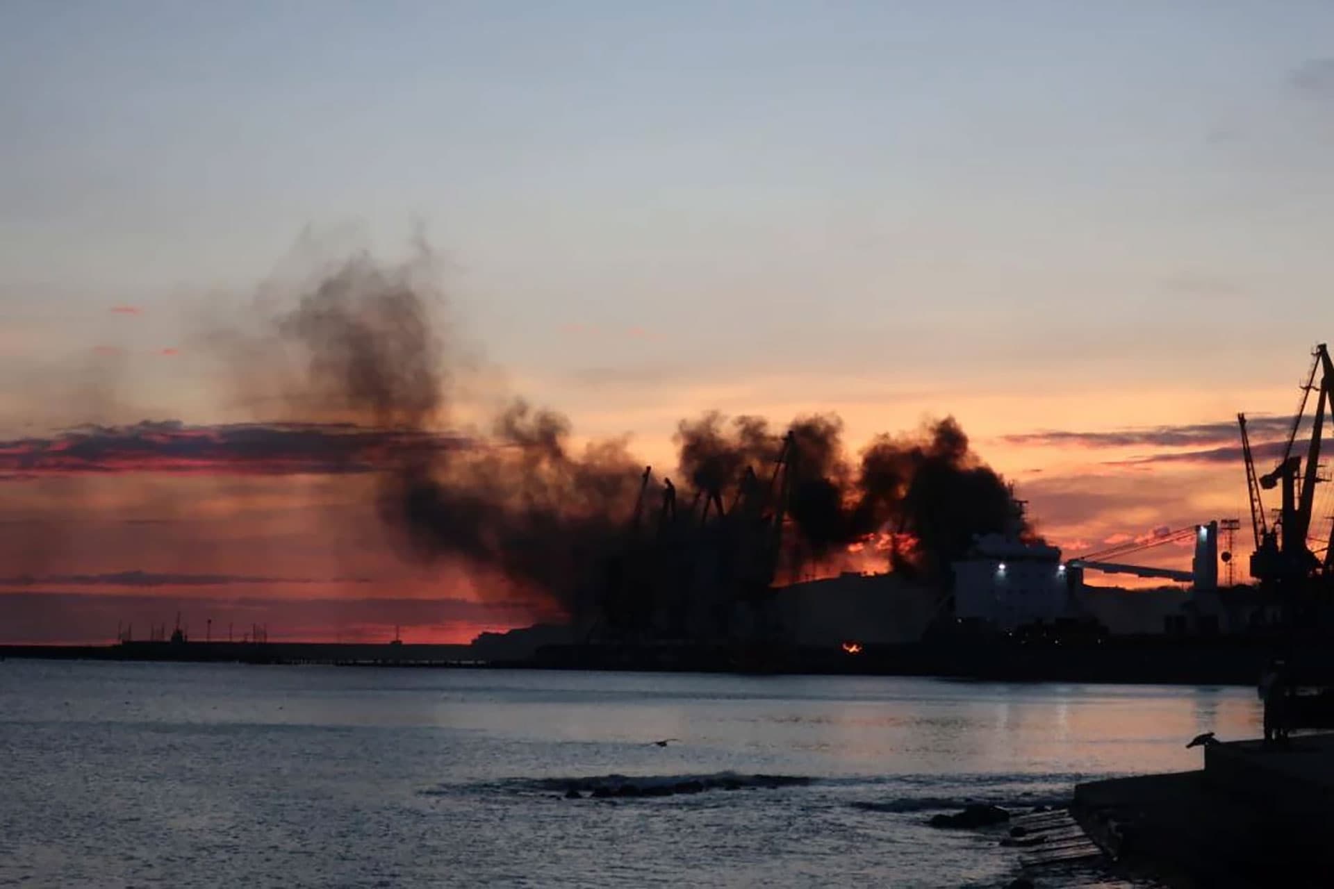 Smoke rising above a damaged russian warship on southern Crimean port of Feodosia
