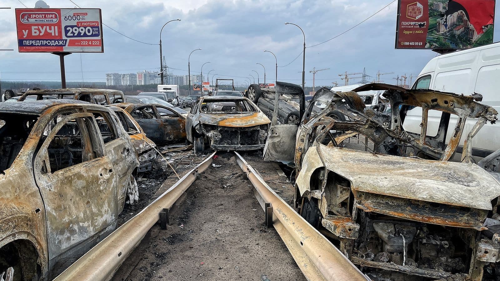Burnt-out cars litter the bridge connecting Irpin with Kyiv
