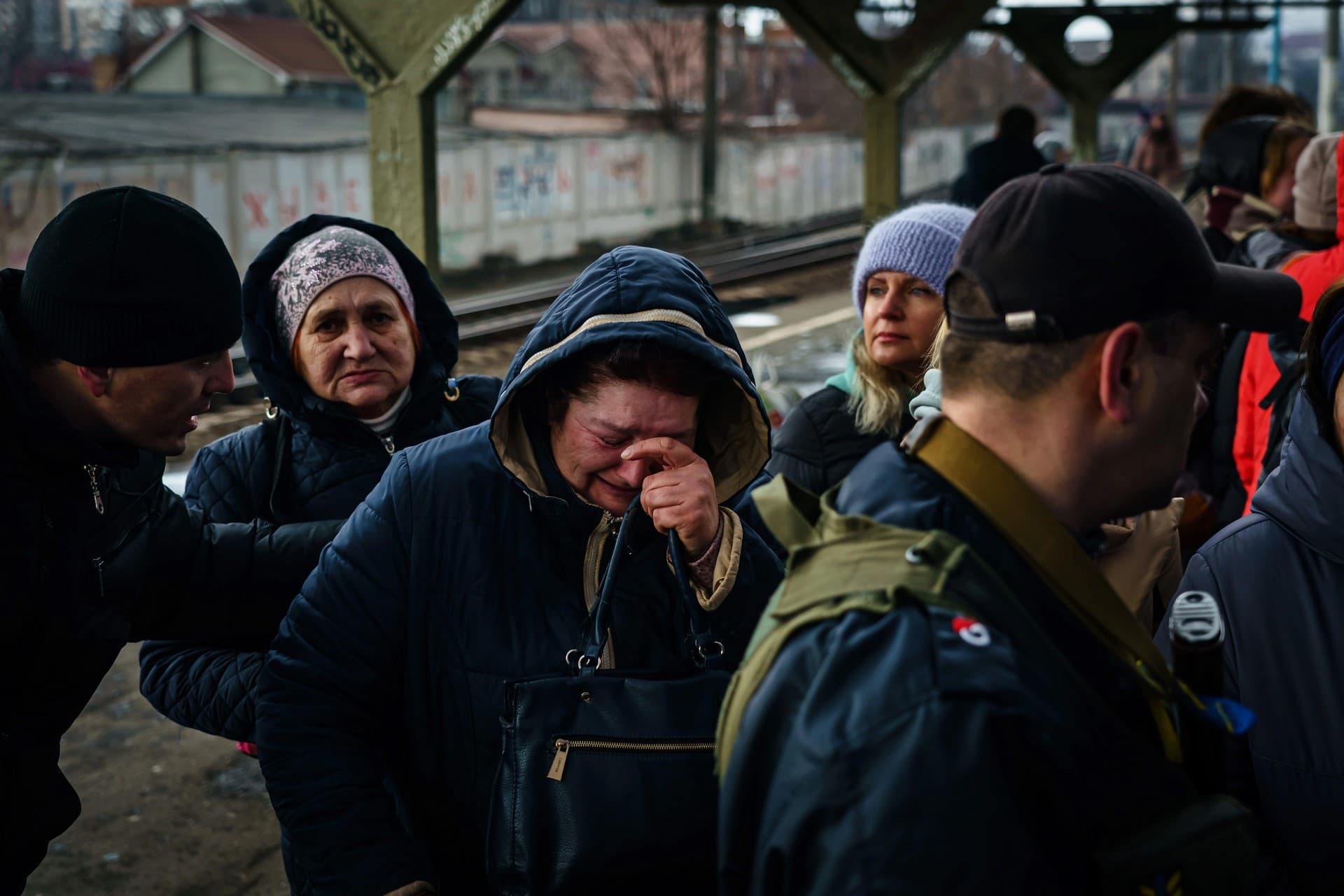 A woman breaks down in tears as she realizes she is getting to board an evacuating train in Irpin