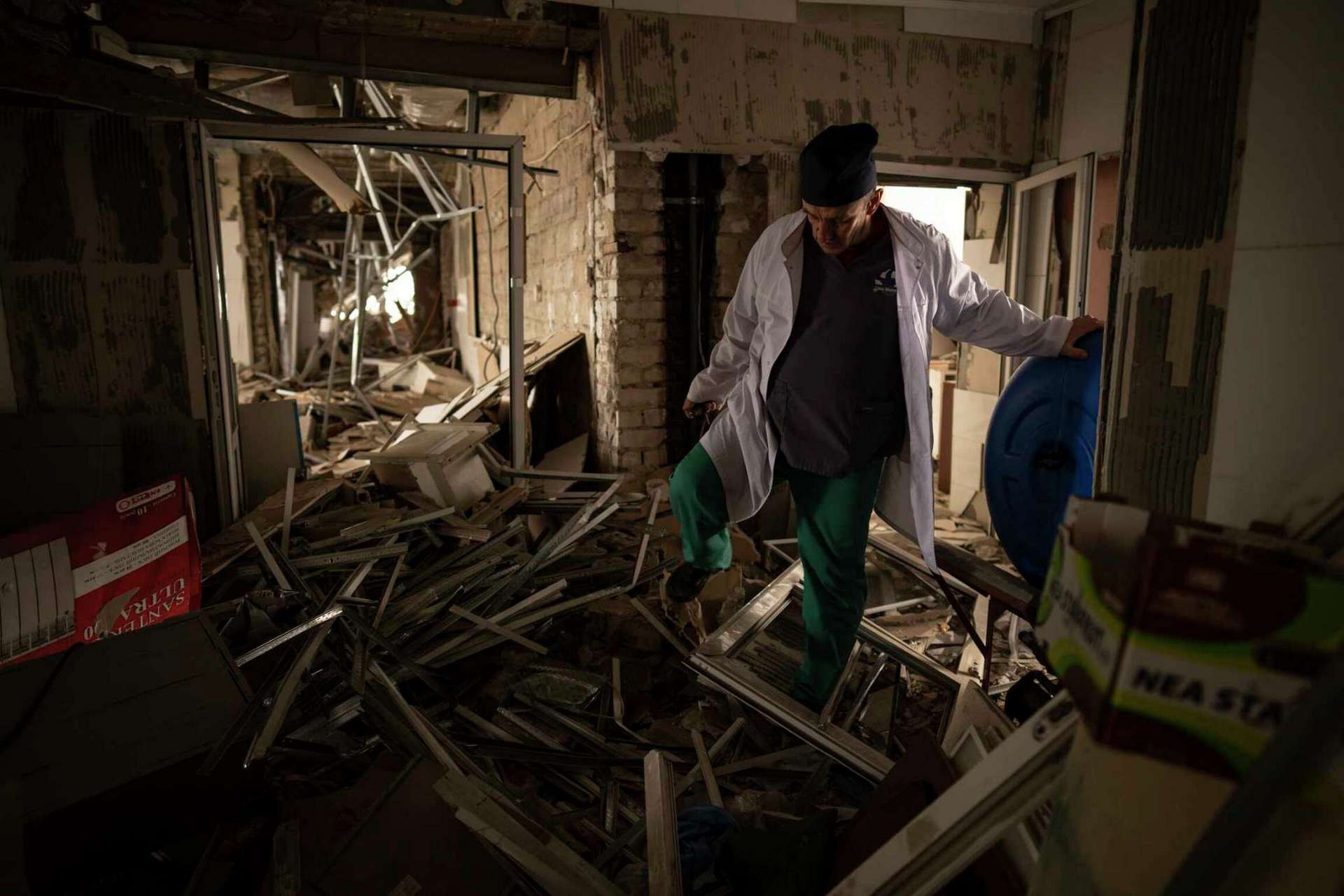 Ukrainian doctor Yurii Kuznetsov walks through the destroyed surgery section of the hospital in Izium
