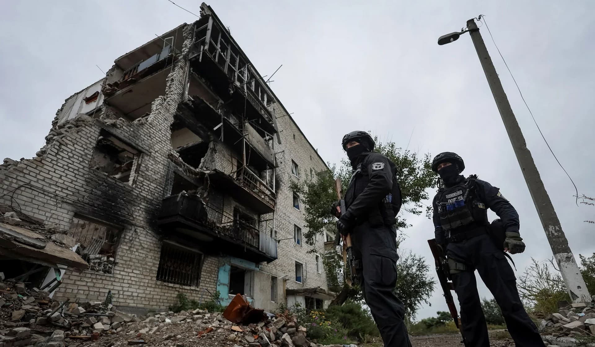 Ukrainian police patrol an area in the town of Izium