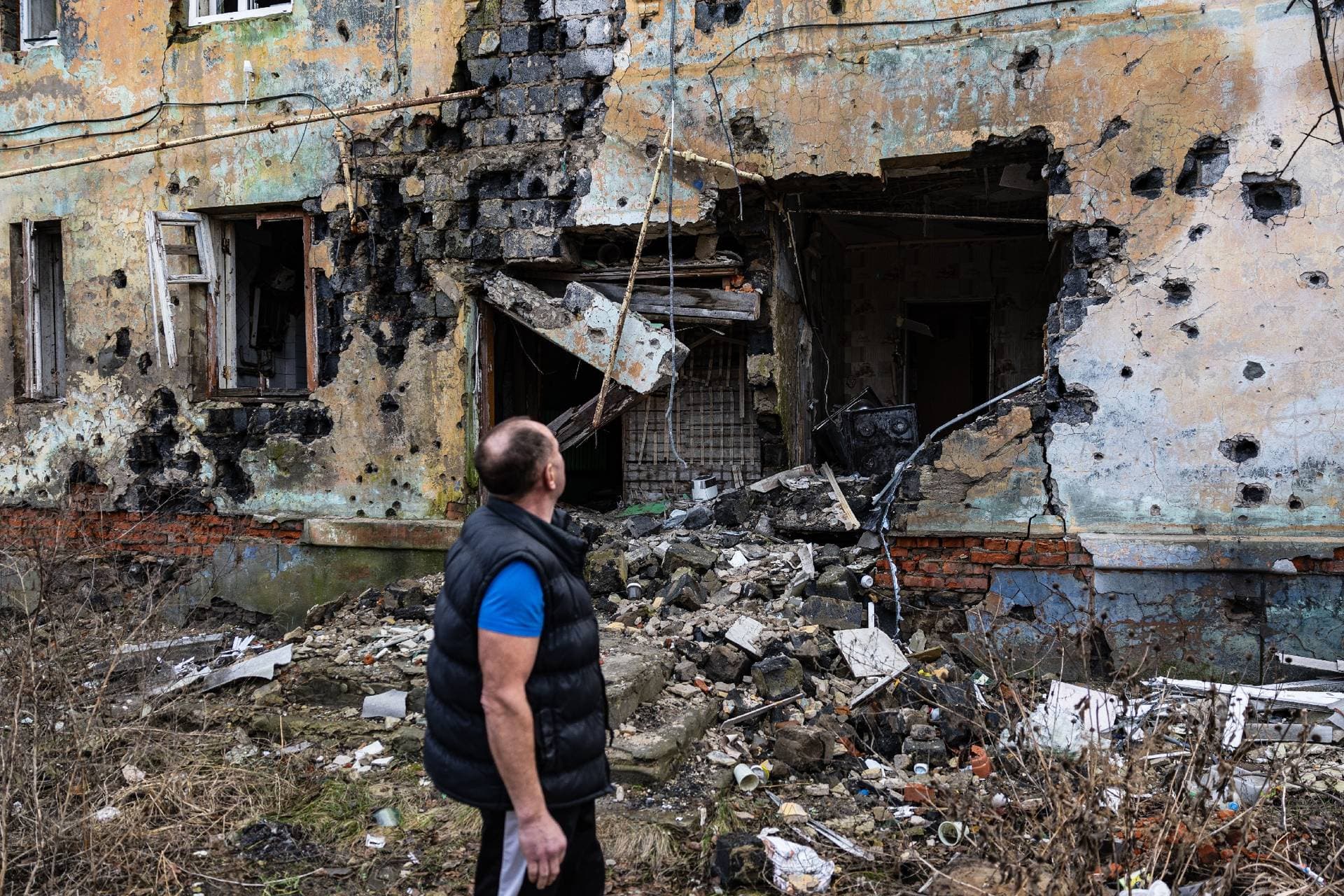Andriy Pleshan views the destruction near his cellar in Izyum