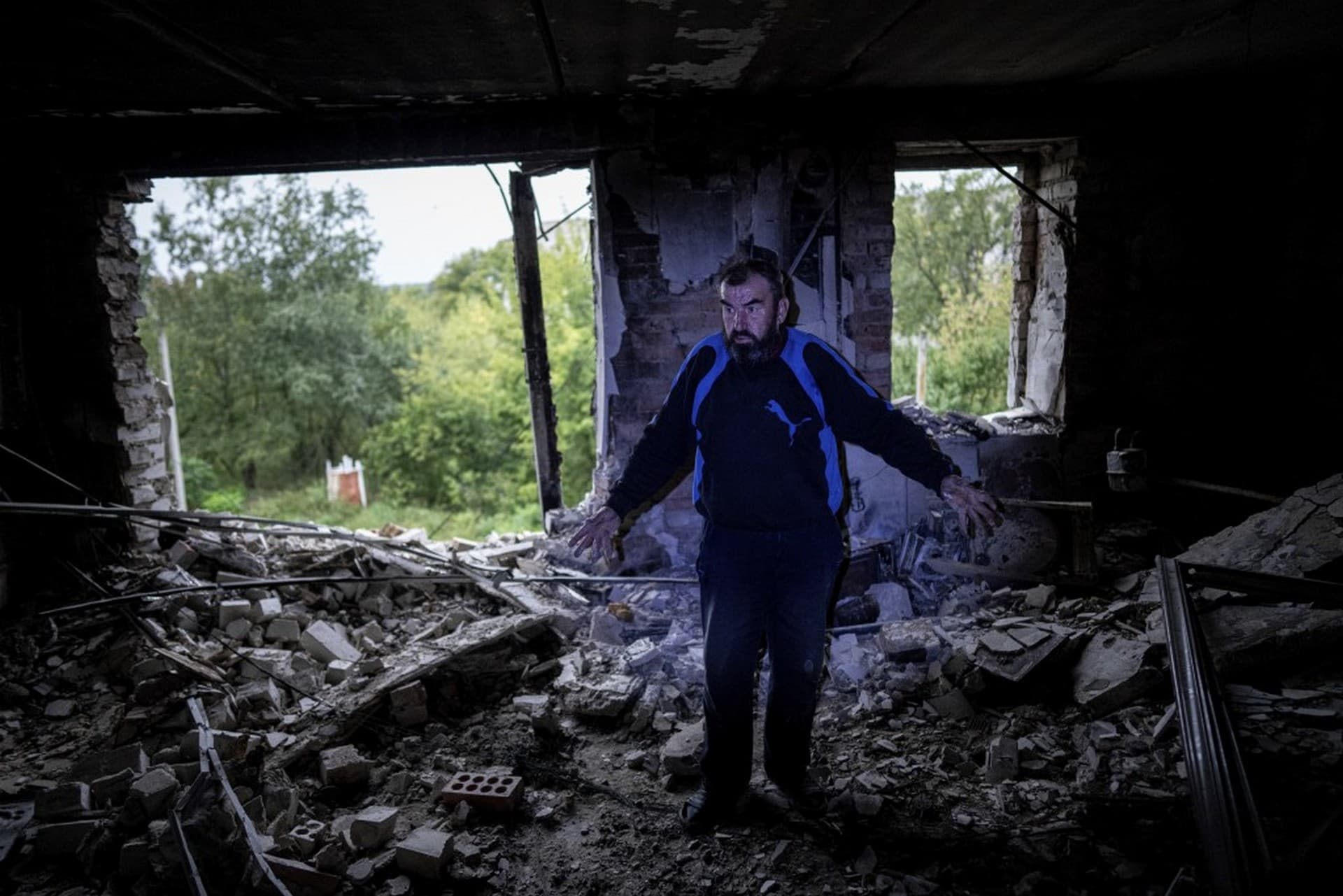 Andrii Iezyk shows the destroyed flat in his house in the recently retaken area of Izium