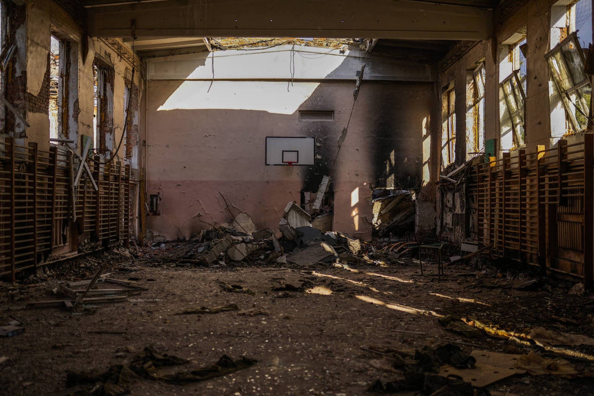 Debris is scattered at the indoor sport pavilion of a destroyed school in Izium