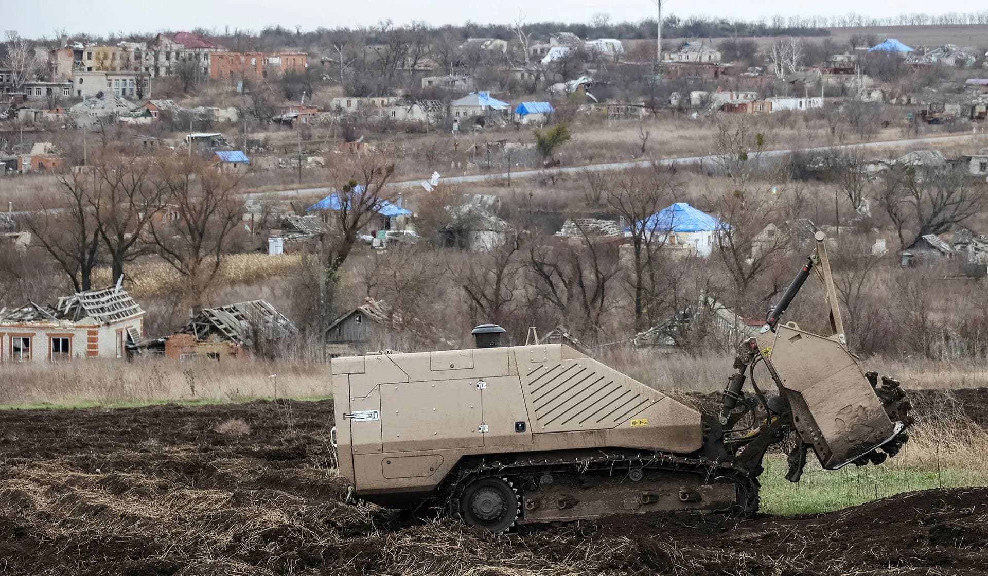 A remote-controlled GCS 200 State Emergency Service deminer vehicle works on a field near the village of Kamianka