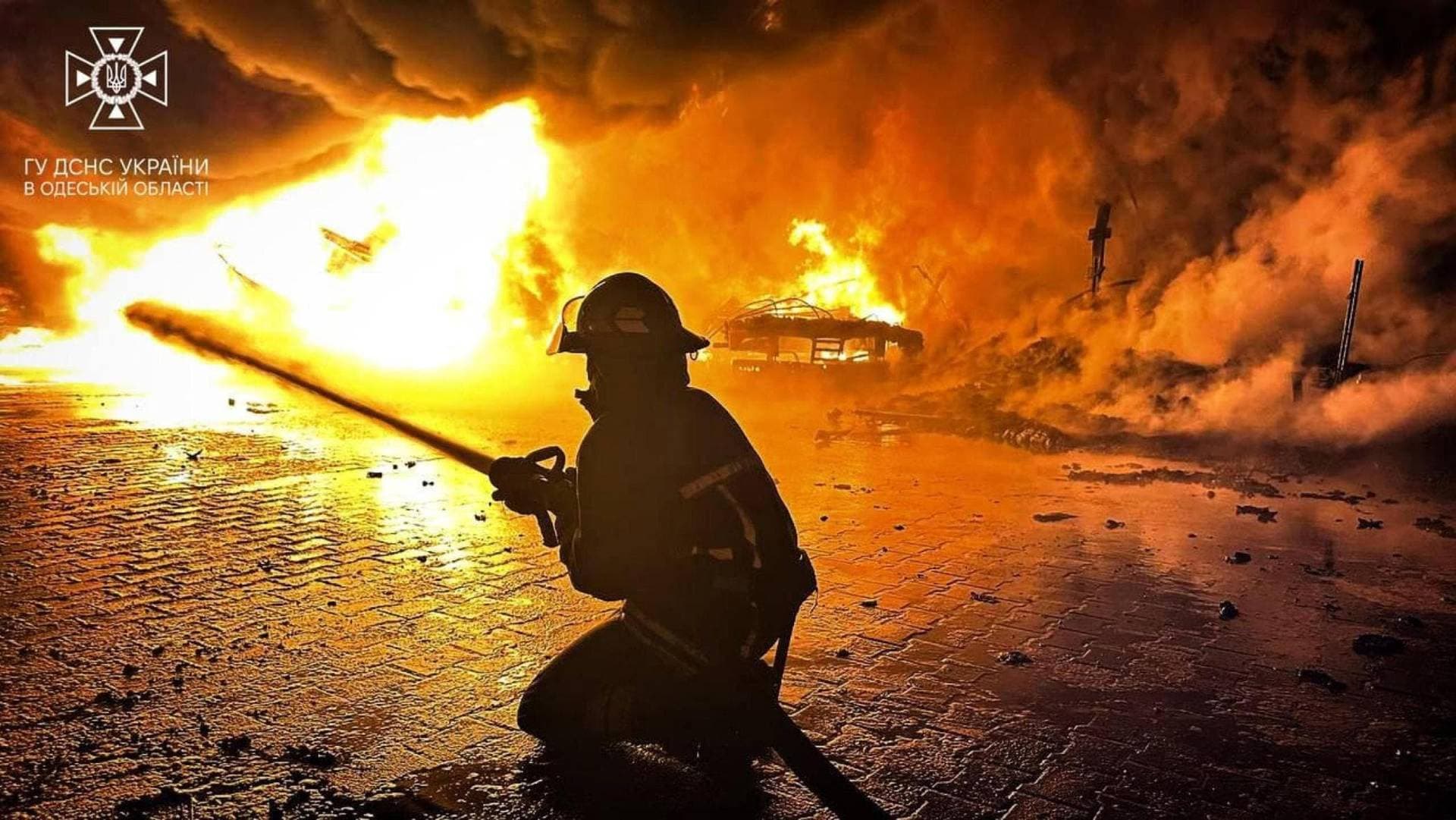 A firefighter works at a compound of a port on the Danube River damaged by a Russian drone strike in Odesa Region