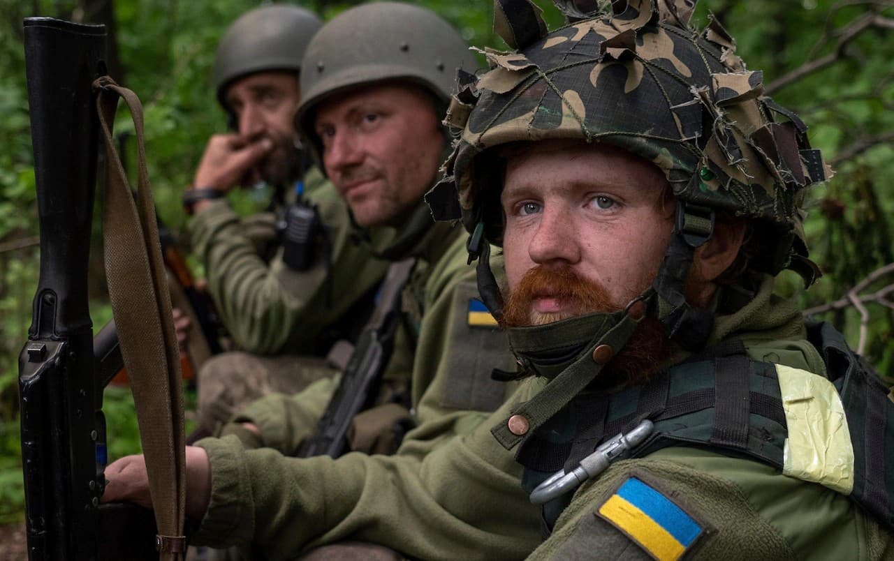 Ukrainian servicemen stop to rest during fighting in Kharkiv