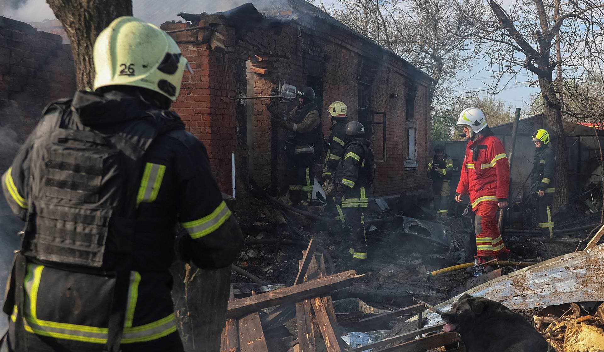 Rescuers work at the site of the private house hit by a Russian drone strike in Kharkiv