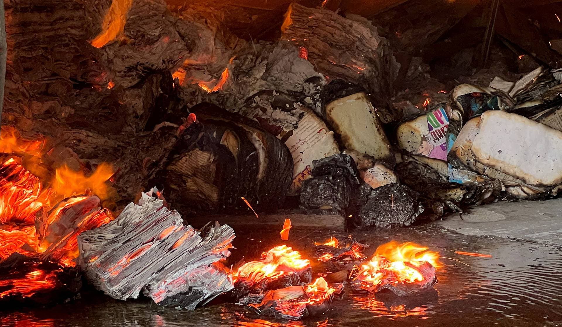 Books burn at the site of a book warehouse hit by a Russian drone strike in Kharkiv