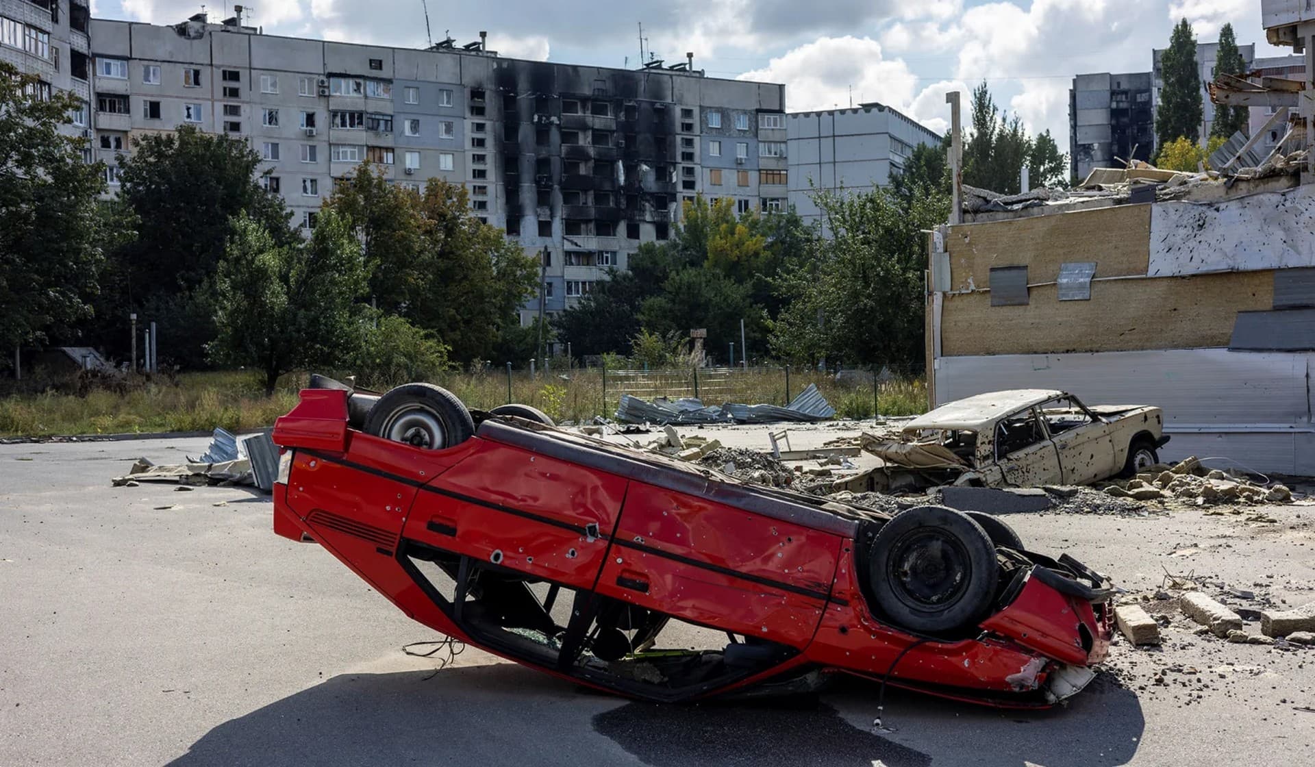 Destroyed buildings and a car in the Saltivka neighbourhood of Kharkiv