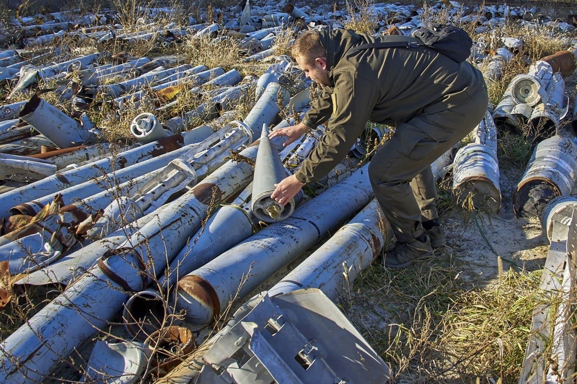 A worker for the prosecutor’s office looks at used missiles collected to be presented as evidence of Russian shellings against civilian targets in Kharkiv