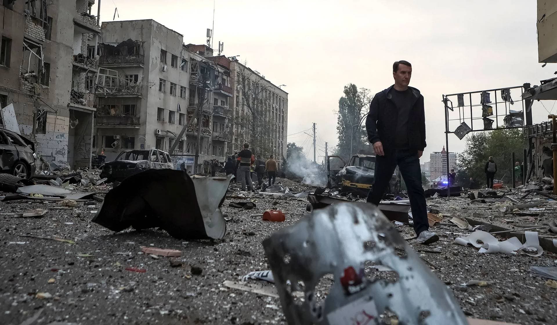 A local resident walks at the site of a Russian missile strike in Kharkiv