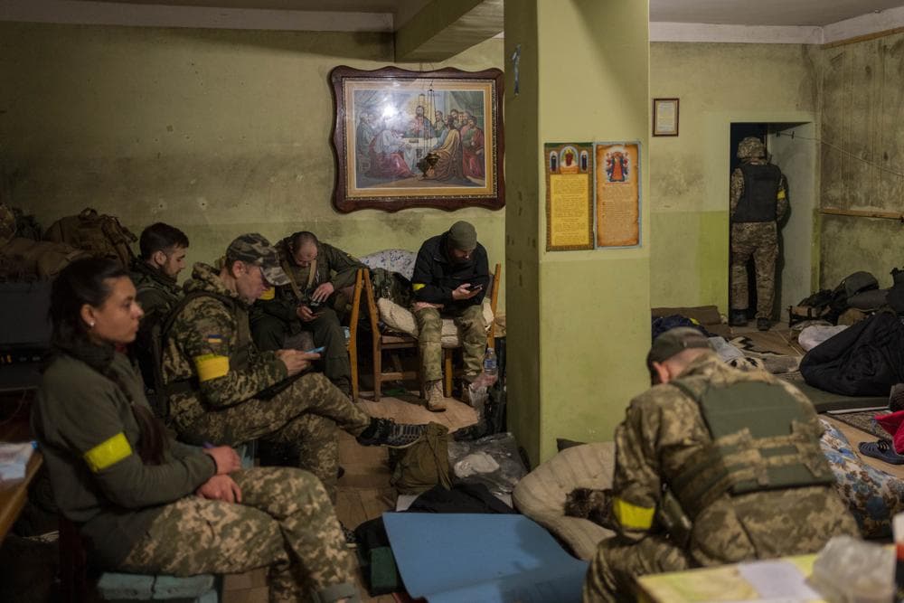 Ukrainian National Guard soldiers take a break in a house used as temporary base in a recently retaken village on the outskirts of Kharkiv