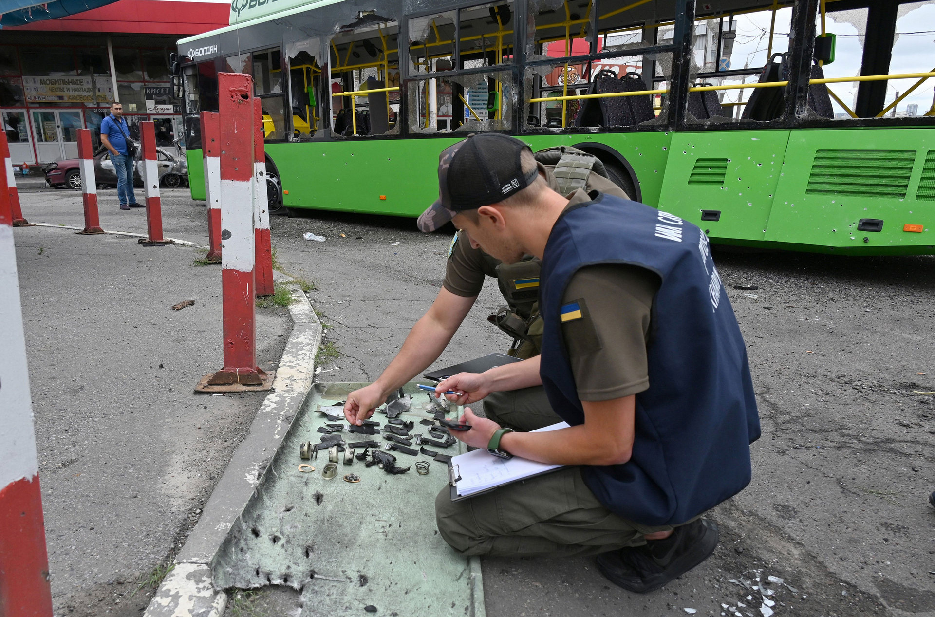 Ukrainian authorities collect fragments after a Russian rocket strike in Kharkiv