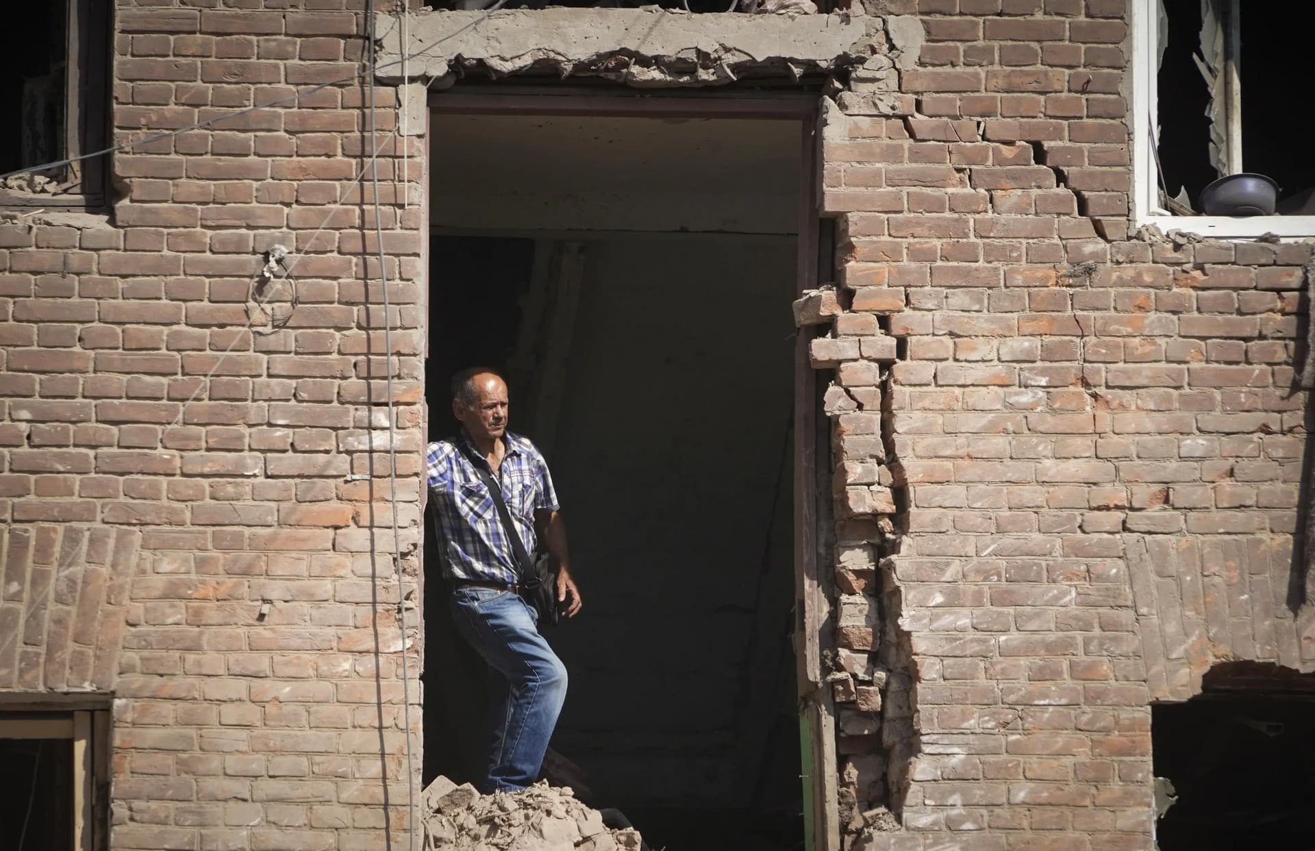 Local resident stands in a building destroyed during a missile strike in Kharkiv