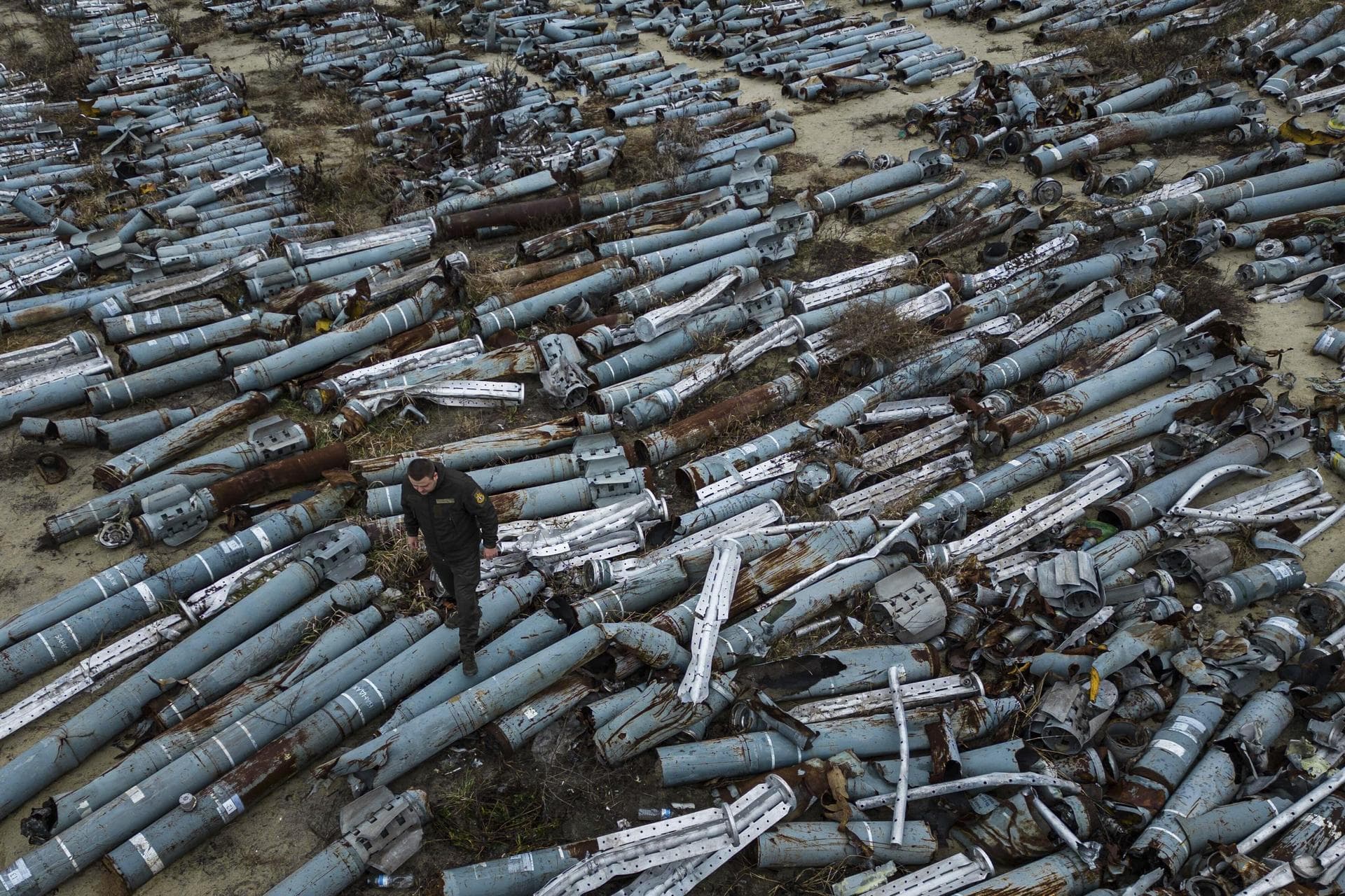 A war prosecutor observes collected parts of Russian rockets which were used to attack the city of Kharkiv, in Kharkiv