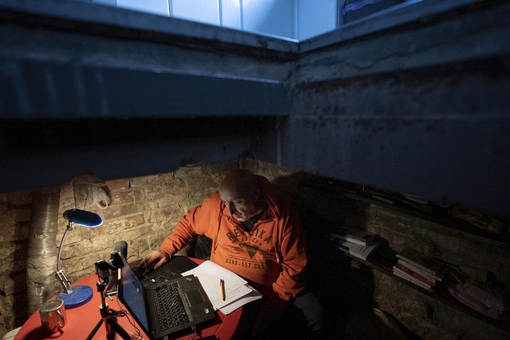 Associate professor of Ukrainian literature Mykhailo Spodarets gives an online lesson from the basement of his house, used as a temporary shelter, in Kharkiv