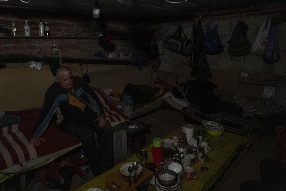 Residents live in the basement of a building used as bomb shelter in the village of Staryi Saltiv, east Kharkiv