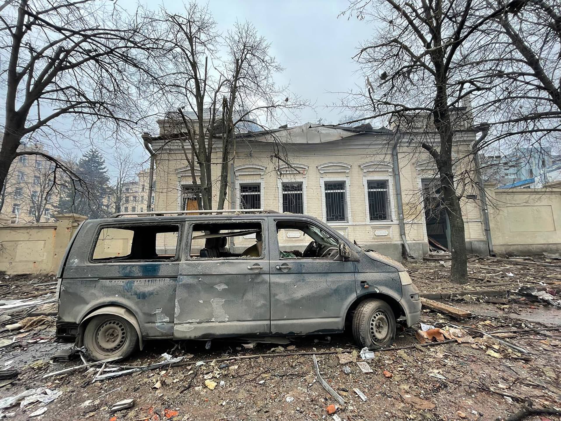 Damaged car and buildings in the city of Kharkiv