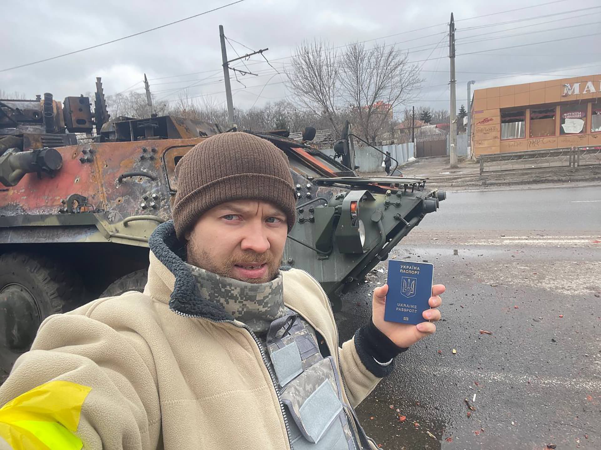 Man standing on the city street with passport. Kharkiv, Ukraine