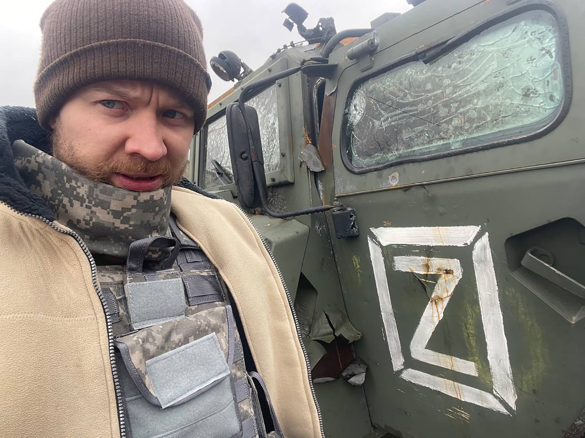 Man standing near Russian military car on the street in Kharkiv