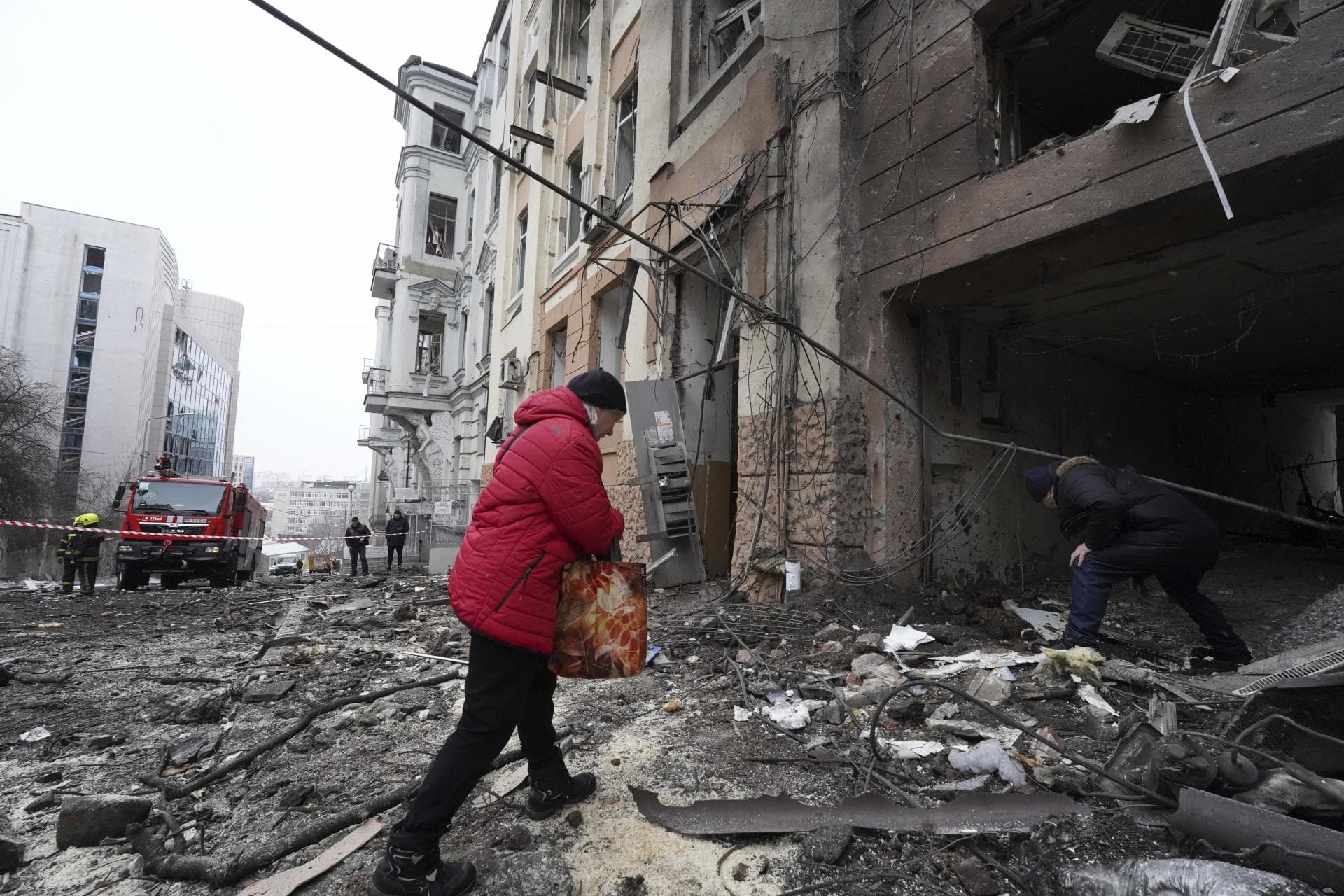Owners of apartments enter a residential building which was hit by a Russian rocket at the city center of Kharkiv