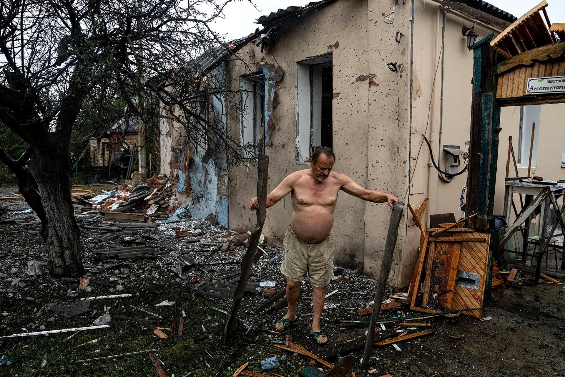 A local man clears rubble from his house which was destroyed after a Russian attack in a residential neighborhood in downtown Kharkiv