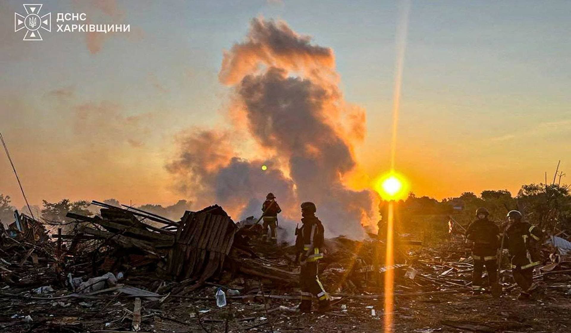 Firefighters work at the site of residential houses hit by overnight Russian drone strikes in the village of Lebiazhe in Kharkiv Region