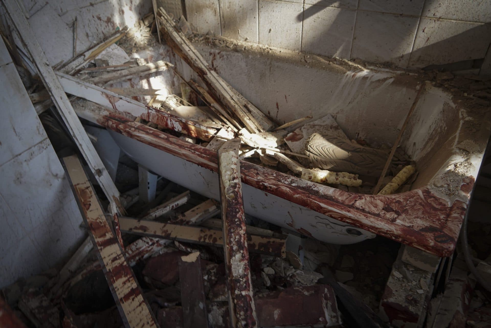 A bloodied bathroom is pictured in building destroyed during a missile strike in Kharkiv