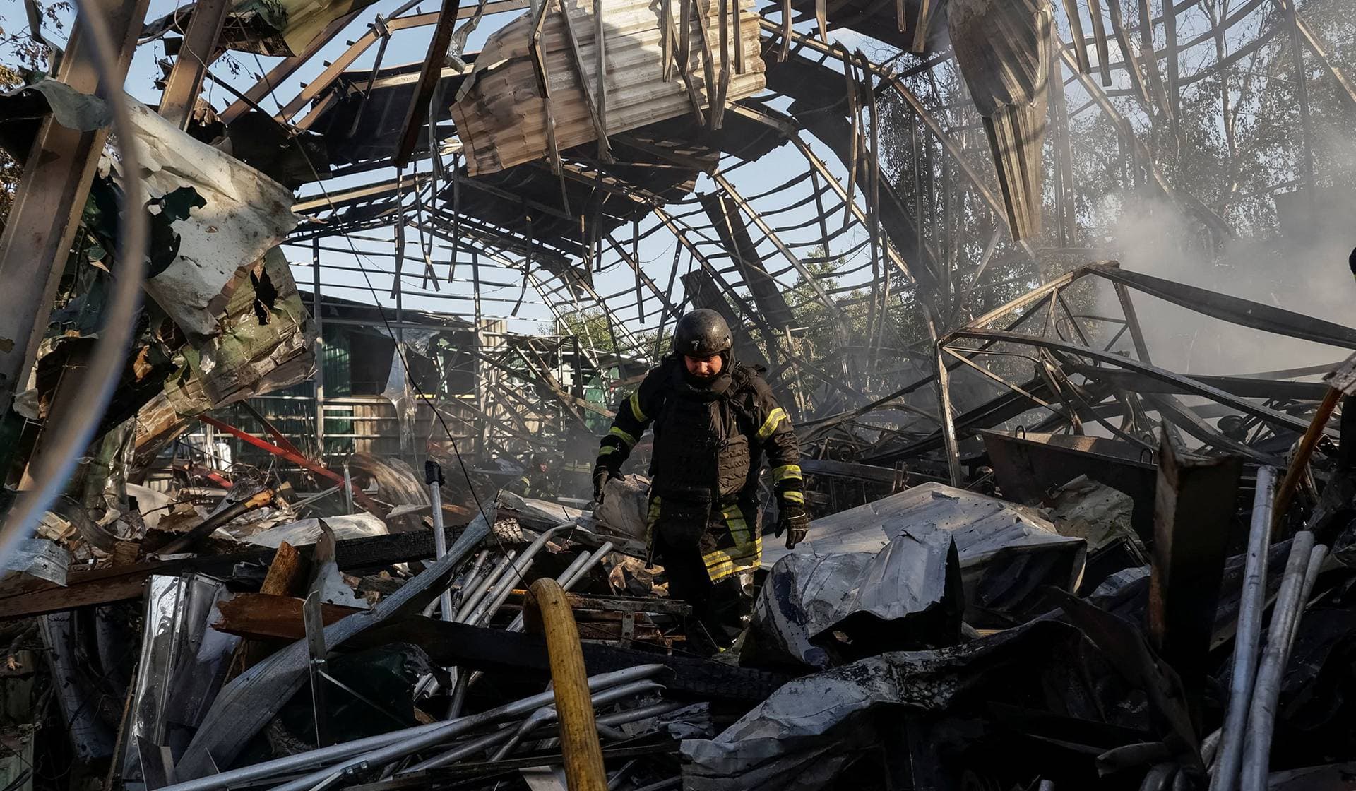 A rescuer works at a site of a Russian air strike in Kharkiv