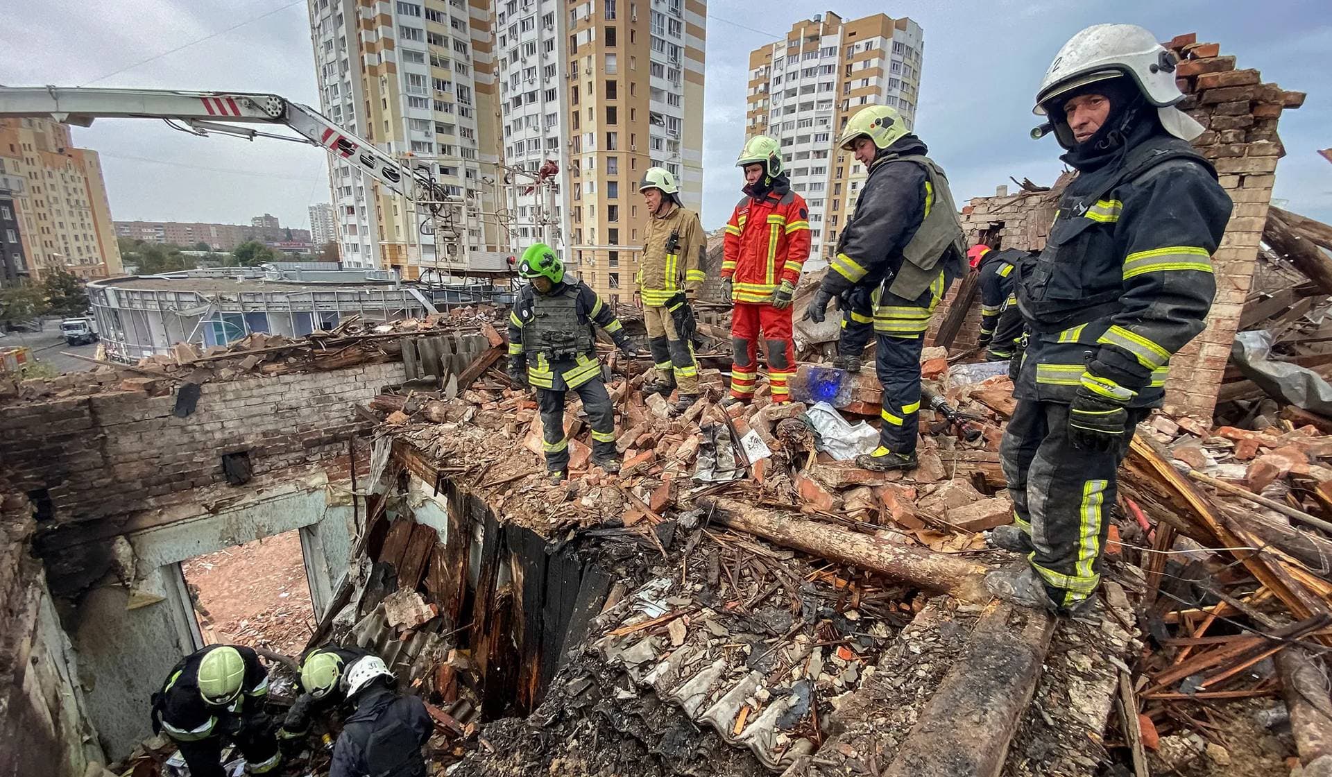 Rescuers work at a site of a residential building damaged by a Russian missile strike in Kharkiv