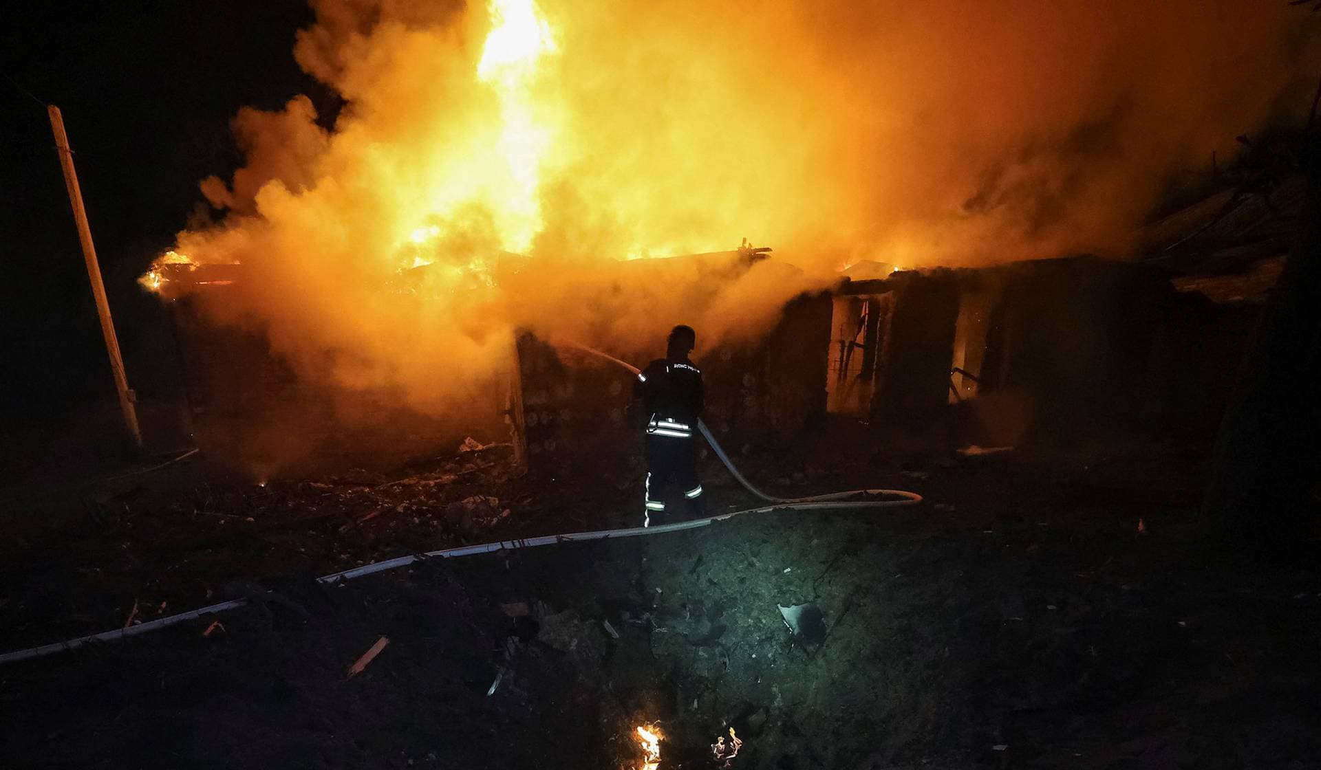 A firefighter works at the site of a Russia drone strike in Kharkiv