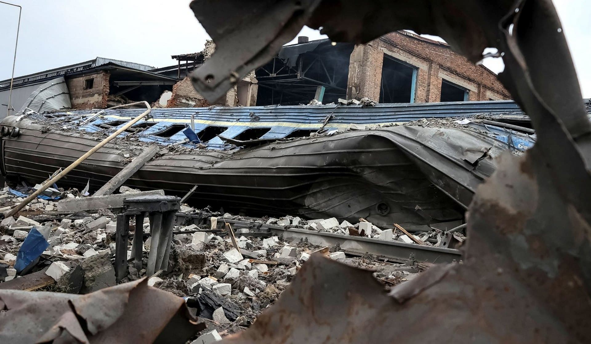 Train cars destroyed by a Russian military strike at a freight railway station in Kharkiv