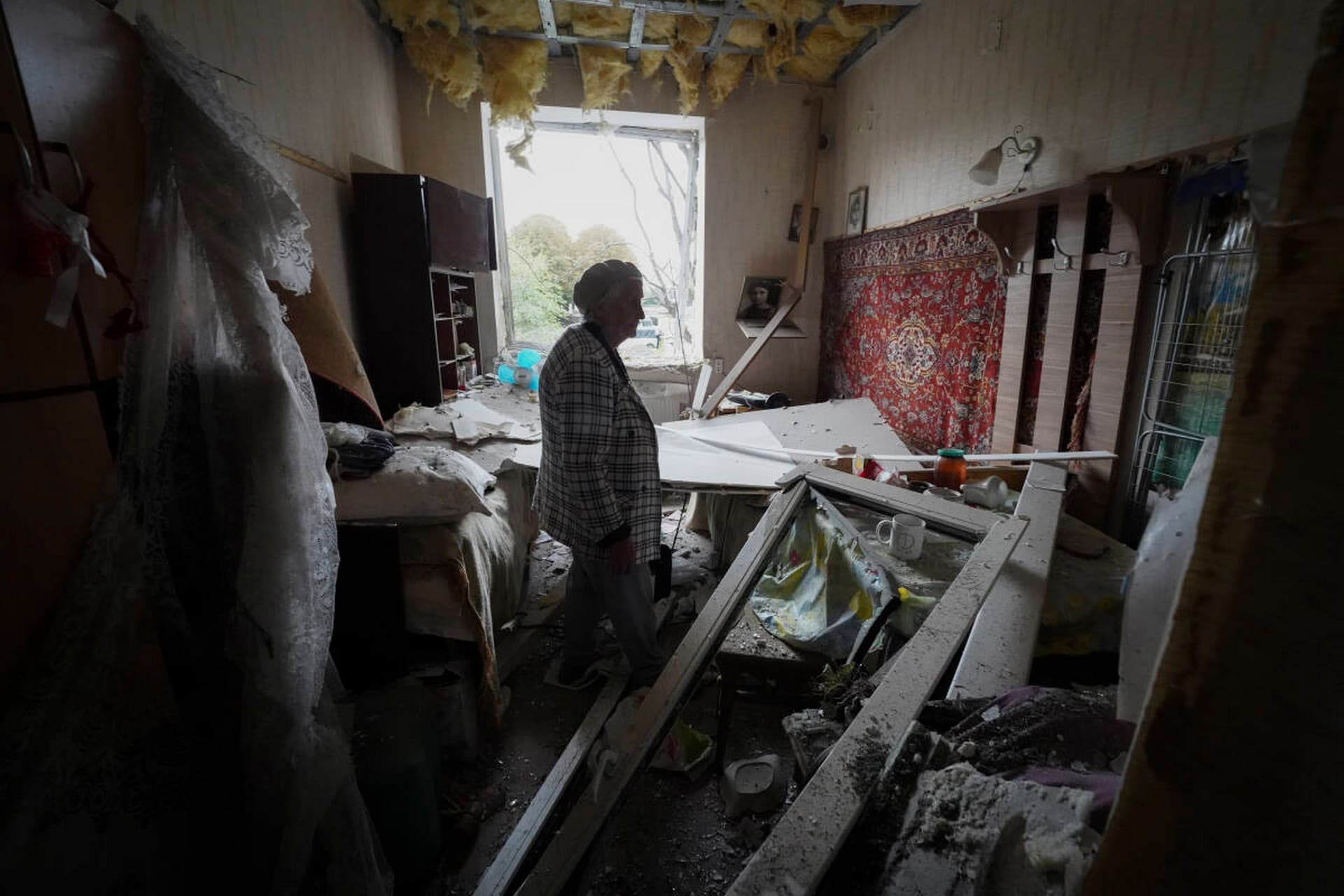 Irina Kuzkova stands in her flat at damaged building after latest Russian rocket attack in downtown Kharkiv