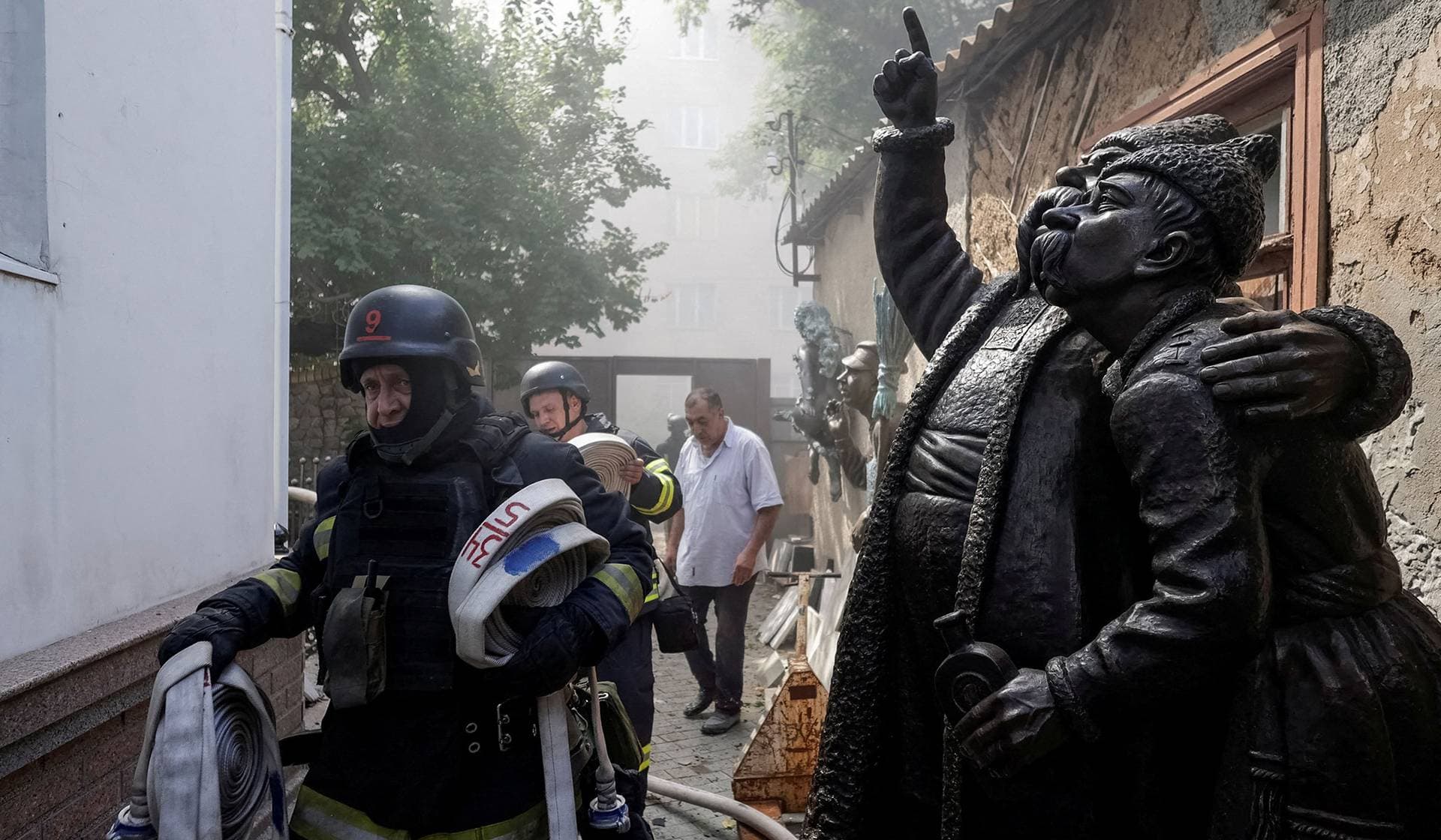 Rescuers work at a site of a local artist's house that was damaged during a Russian drone strike in Kharkiv
