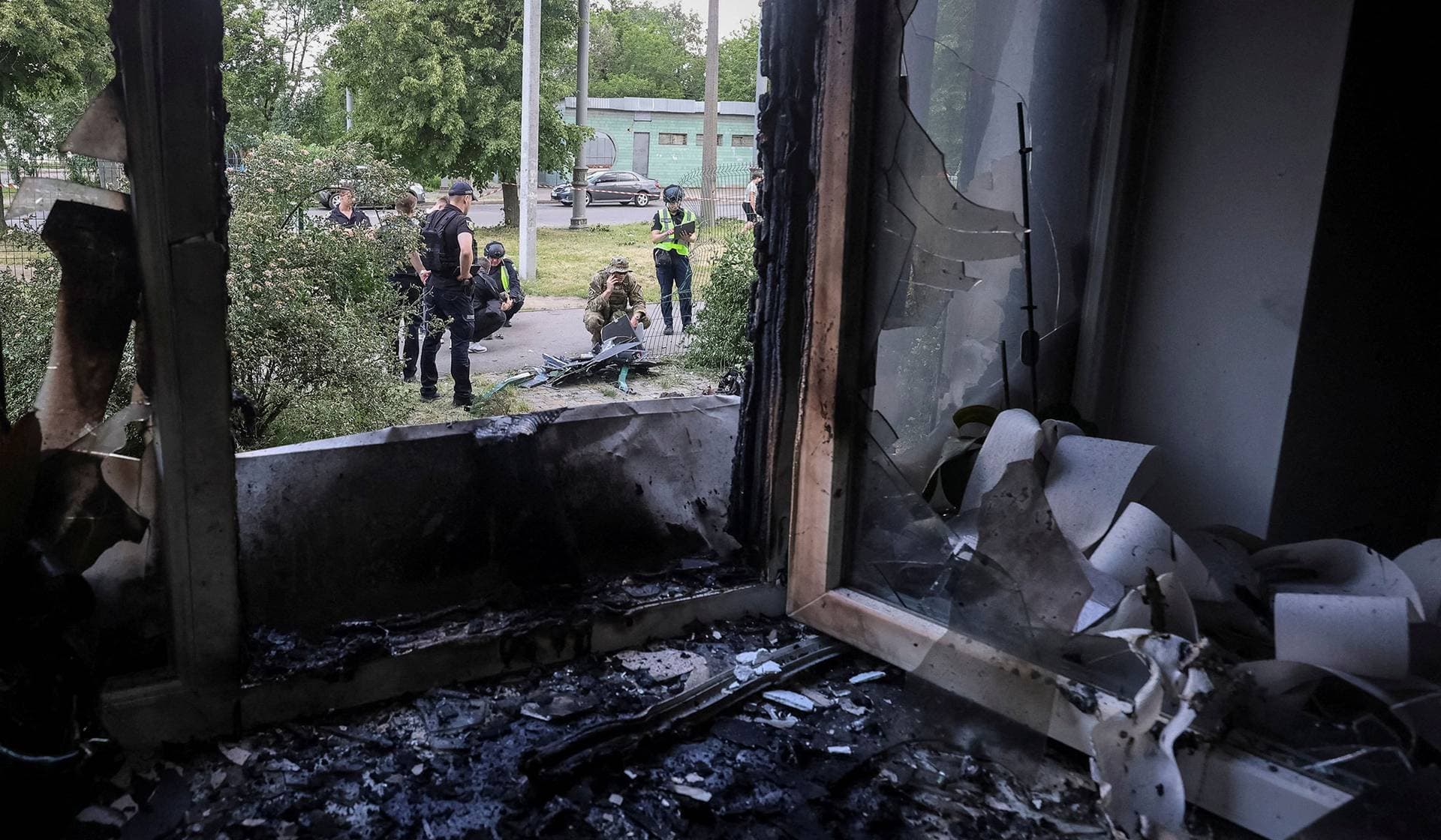 Police experts work at the site of a Russian drone strike in Kharkiv