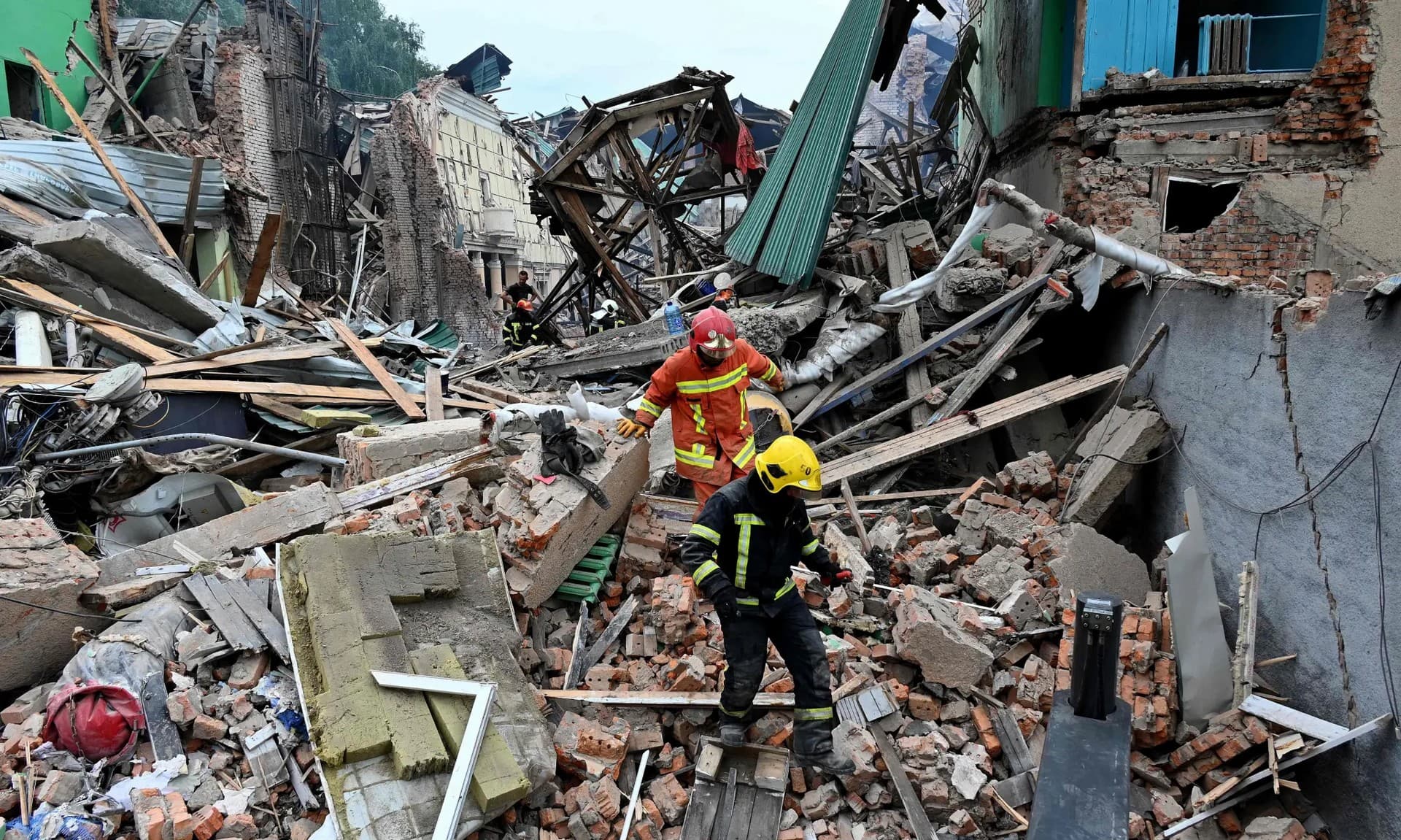 Rescue teams dig through the rubble of buildings destroyed in Kharkiv