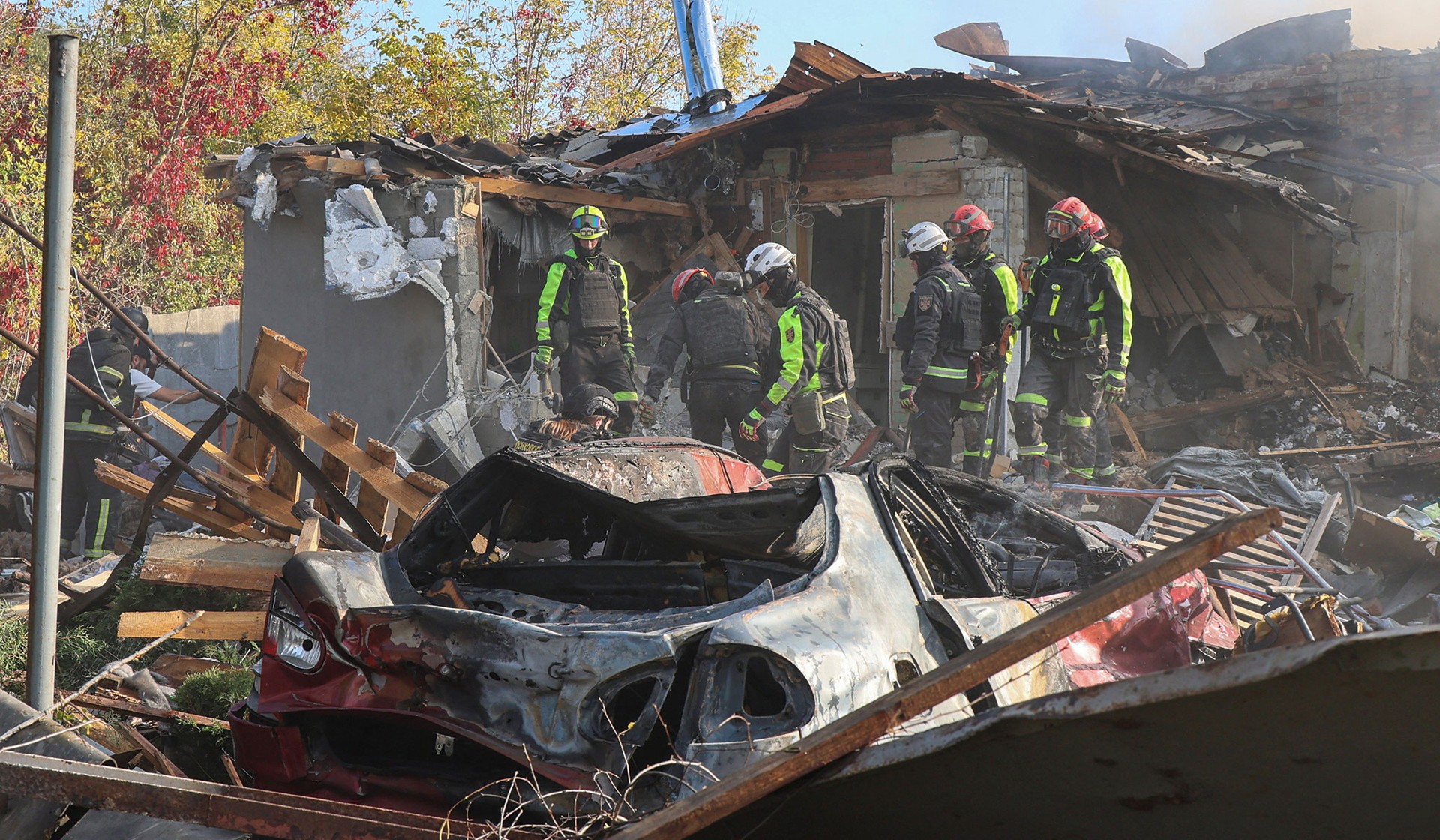 Rescuers work at the site of private houses hit by a Russian air strike in Kharkiv