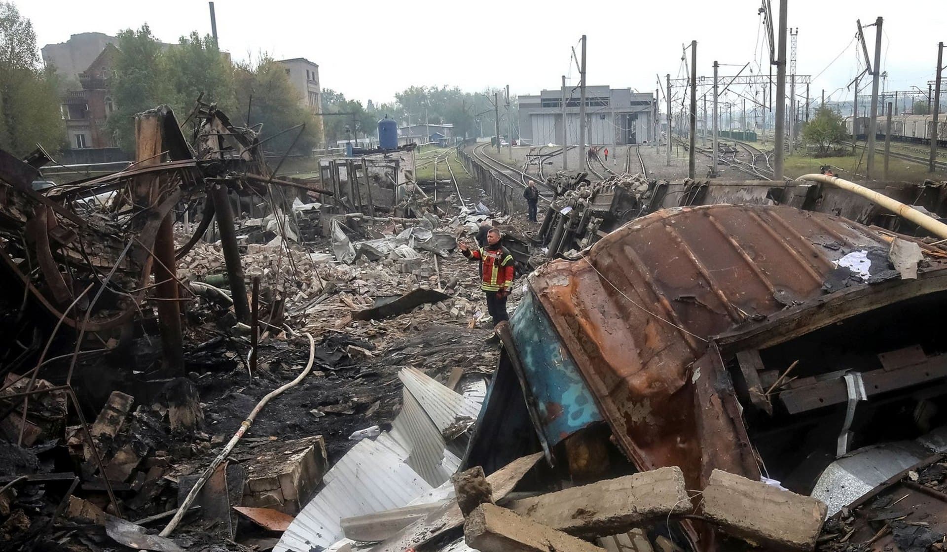 Ukrainian firefighter works at destroyed by a Russian military strike at a freight railway station in Kharkiv