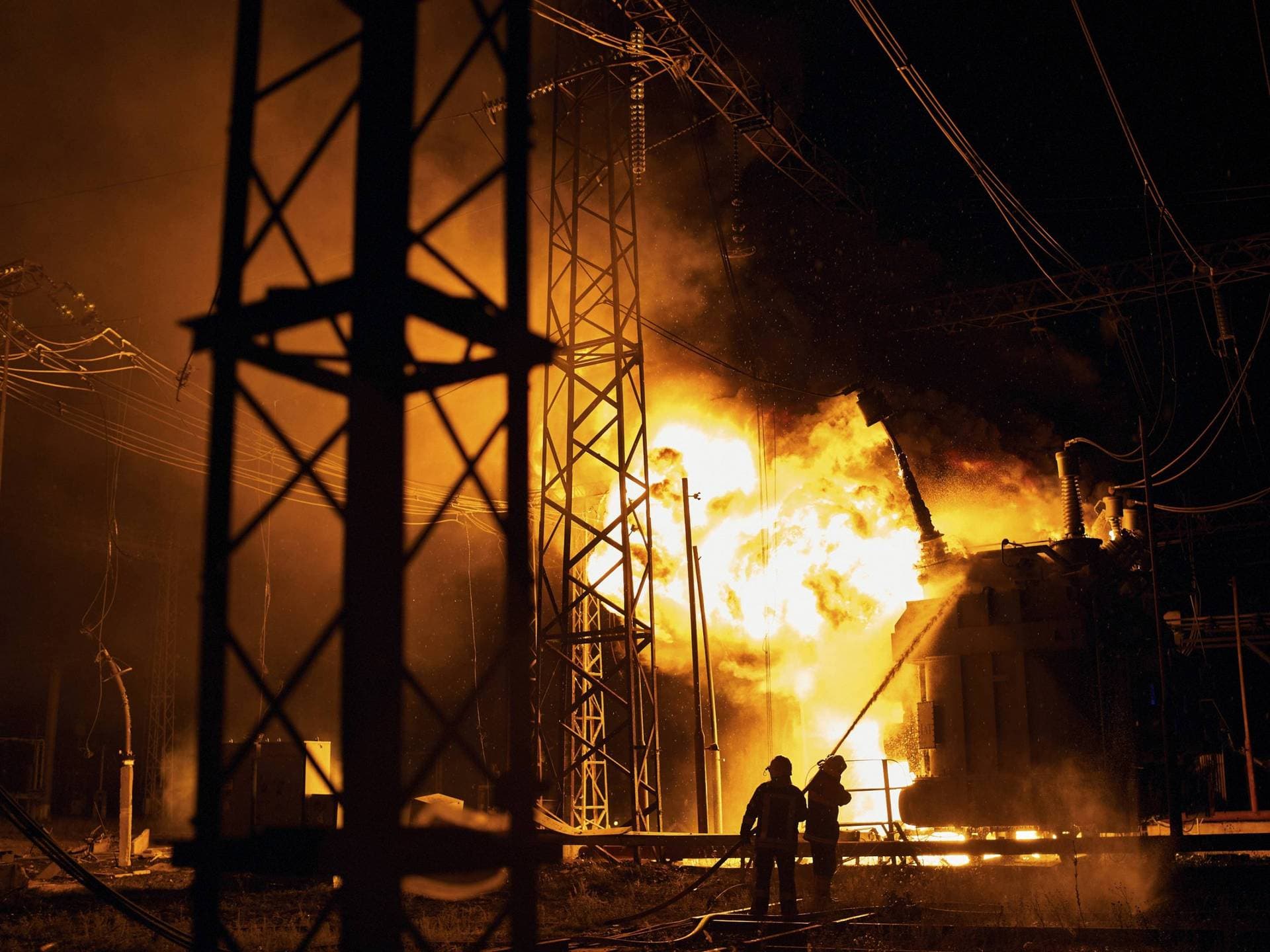 Ukrainian State Emergency Service firefighters put out a fire after a Russian rocket attack hit an electric power station in Kharkiv