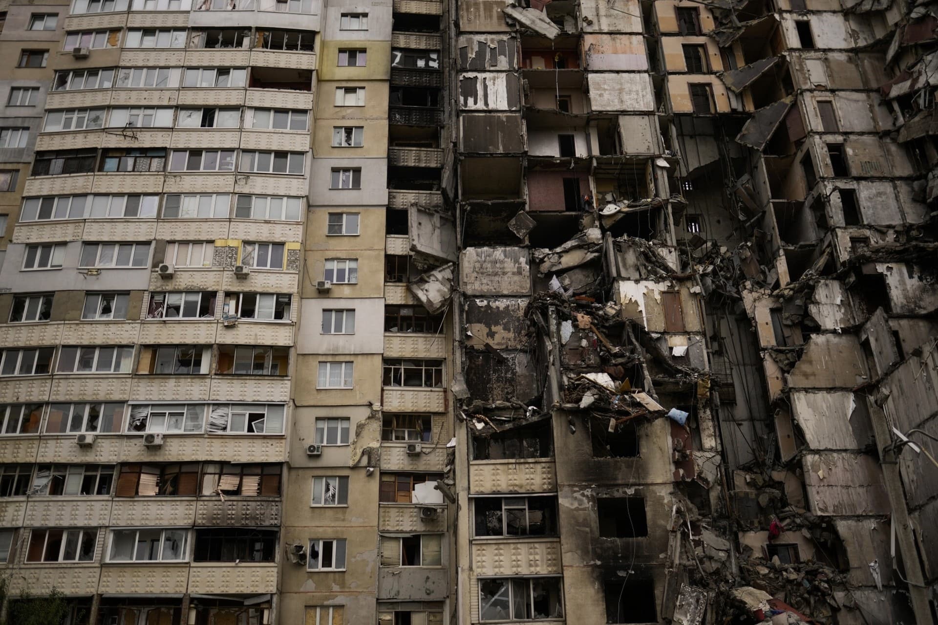 Debris hang from a partially destroyed residential building at Saltivka neighbourhood in Kharkiv