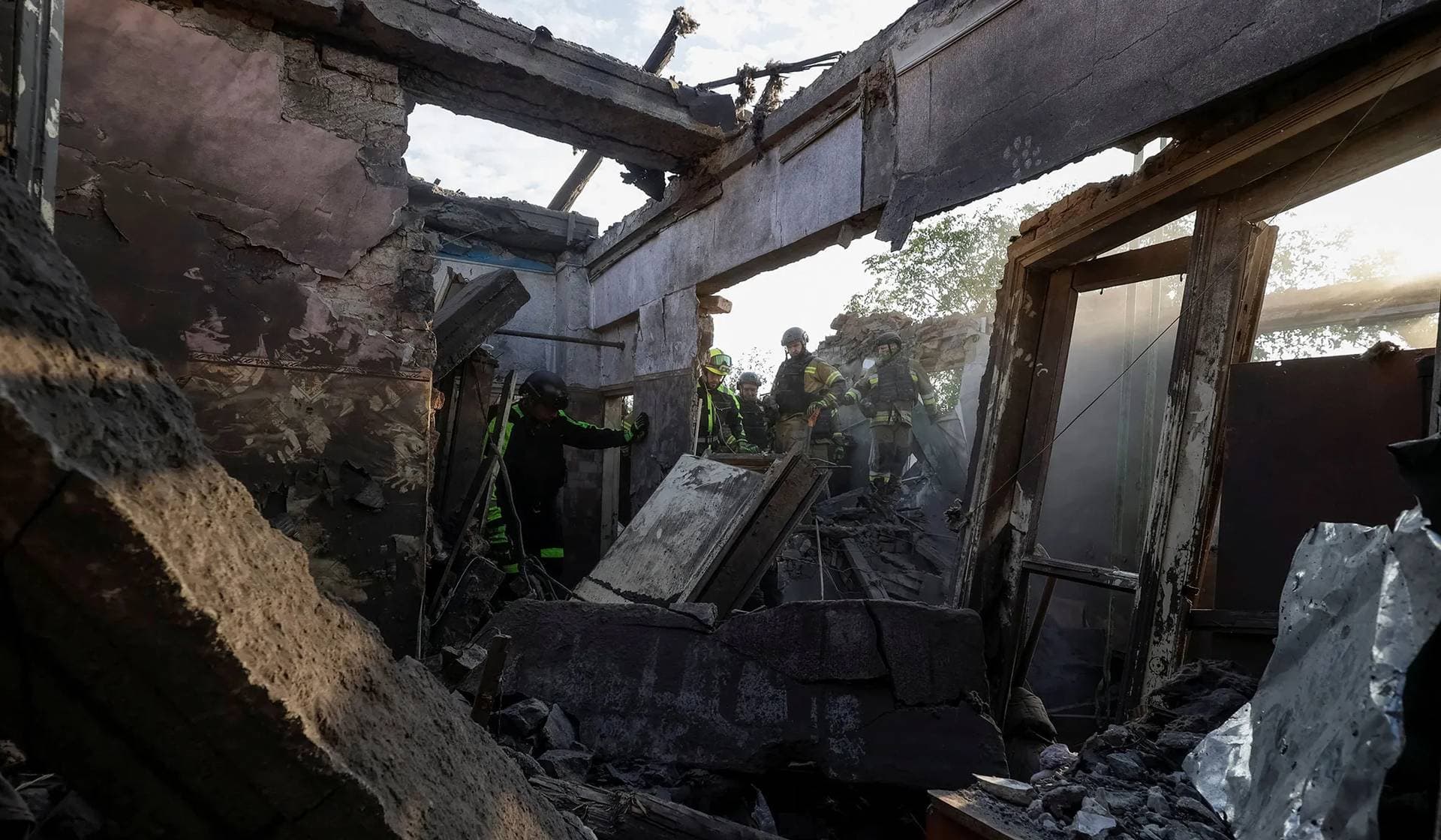 Rescuers work at a site of an apartment building hit by a Russian air strike in Kharkiv