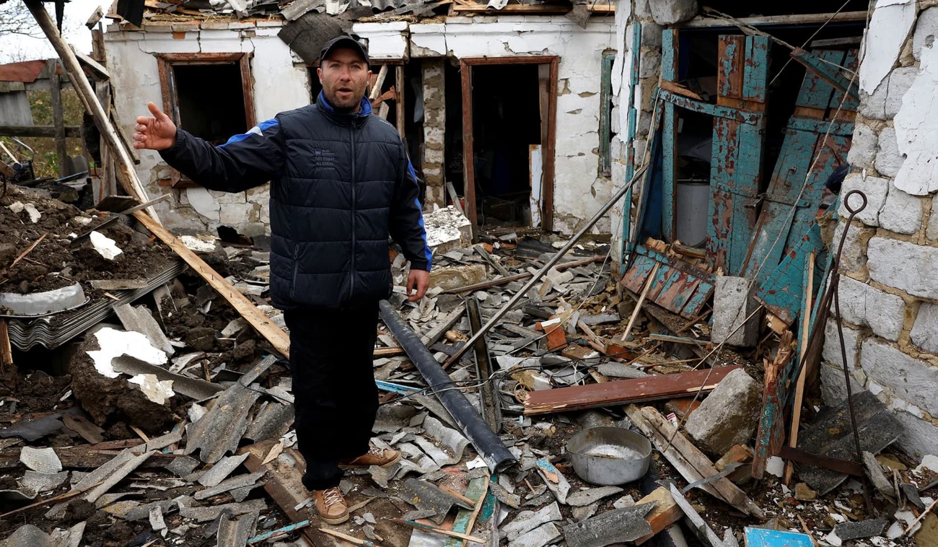 Alexei walks through his home which was damaged in a missile strike near the Russian border in Kharkiv Region