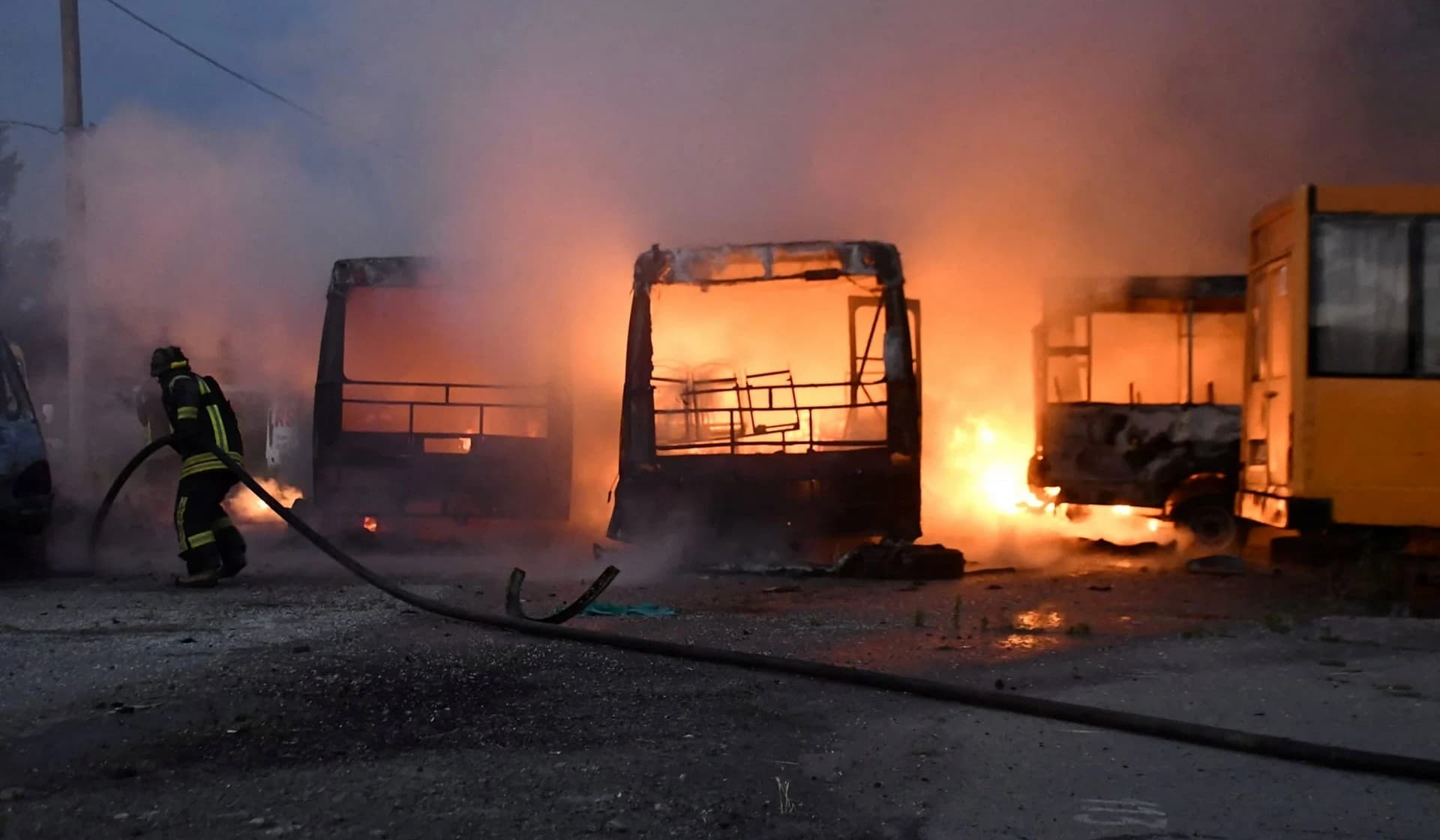 Firefighters work at the site of a transport company hit by a Russian military strike in Kherson