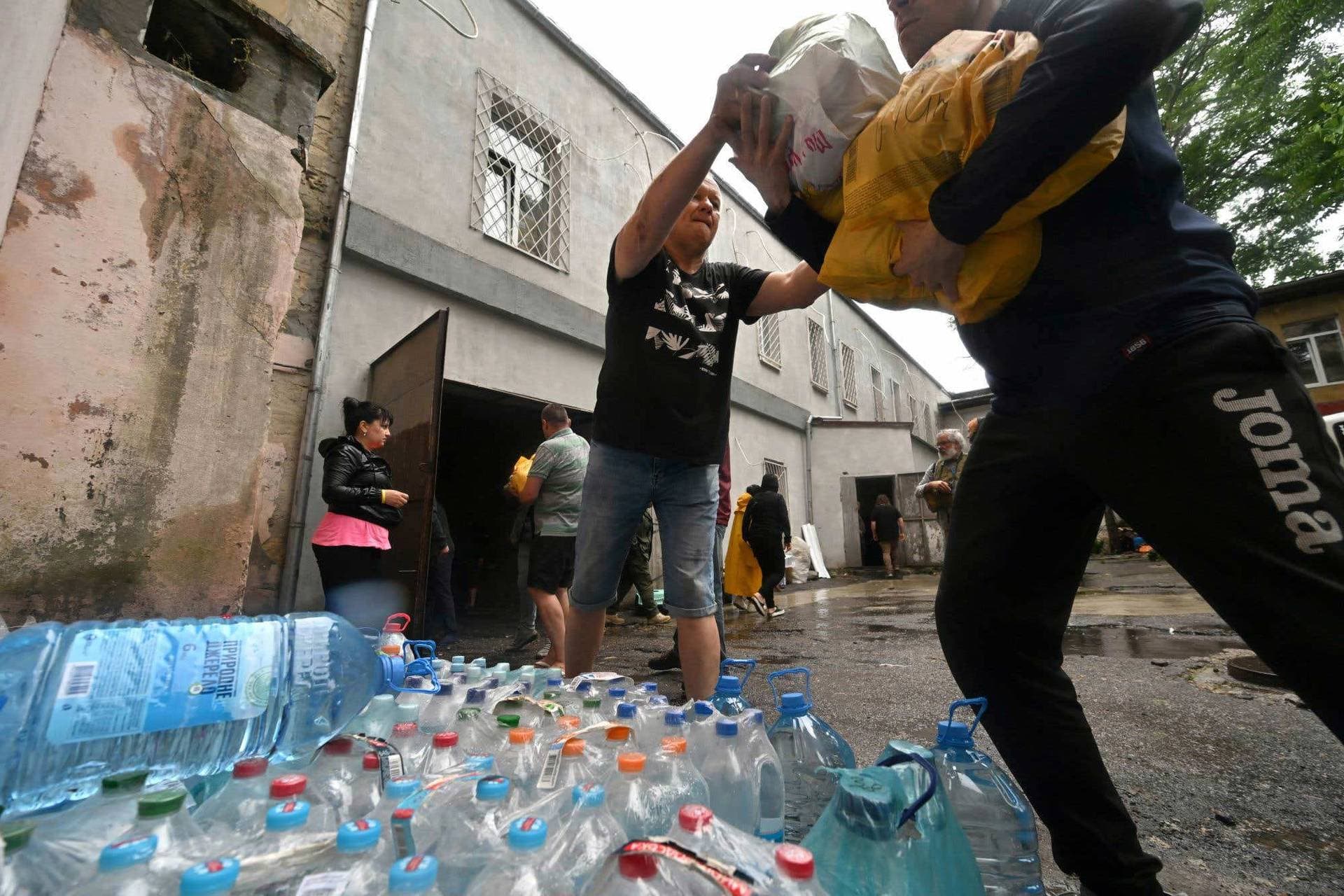 Volunteers unload goods donated for residents of flooded areas in Kherson