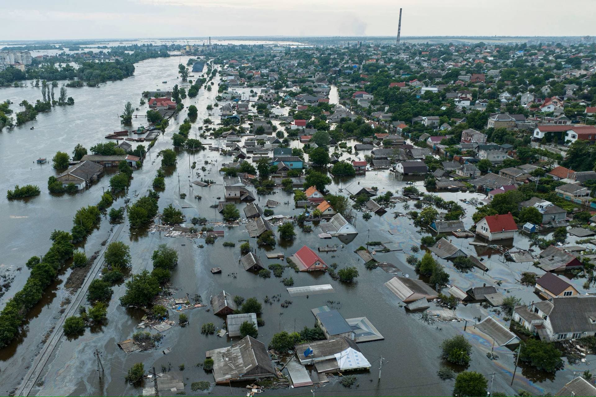 Houses are seen underwater and polluted by oil in a flooded neighbourhood in Kherson