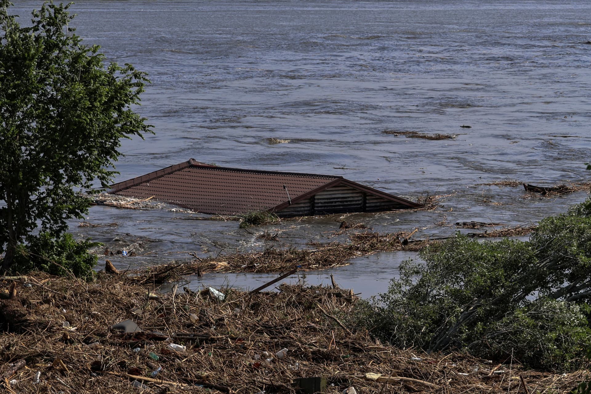 The roof of a house is seen in the flooded Dnipro river in Kherson